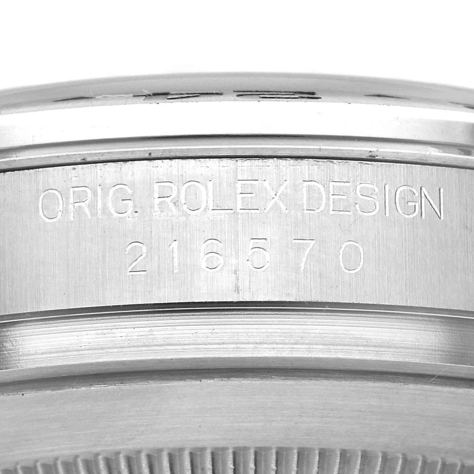 The image shows an angled close-up of the case side of a Rolex Explorer 216570 Men's Stainless Steel Black Dial 216570 Men's Stainless Steel Black Dial watch, displaying the model number "216570" and "ORIG. ROLEX DESIGN."