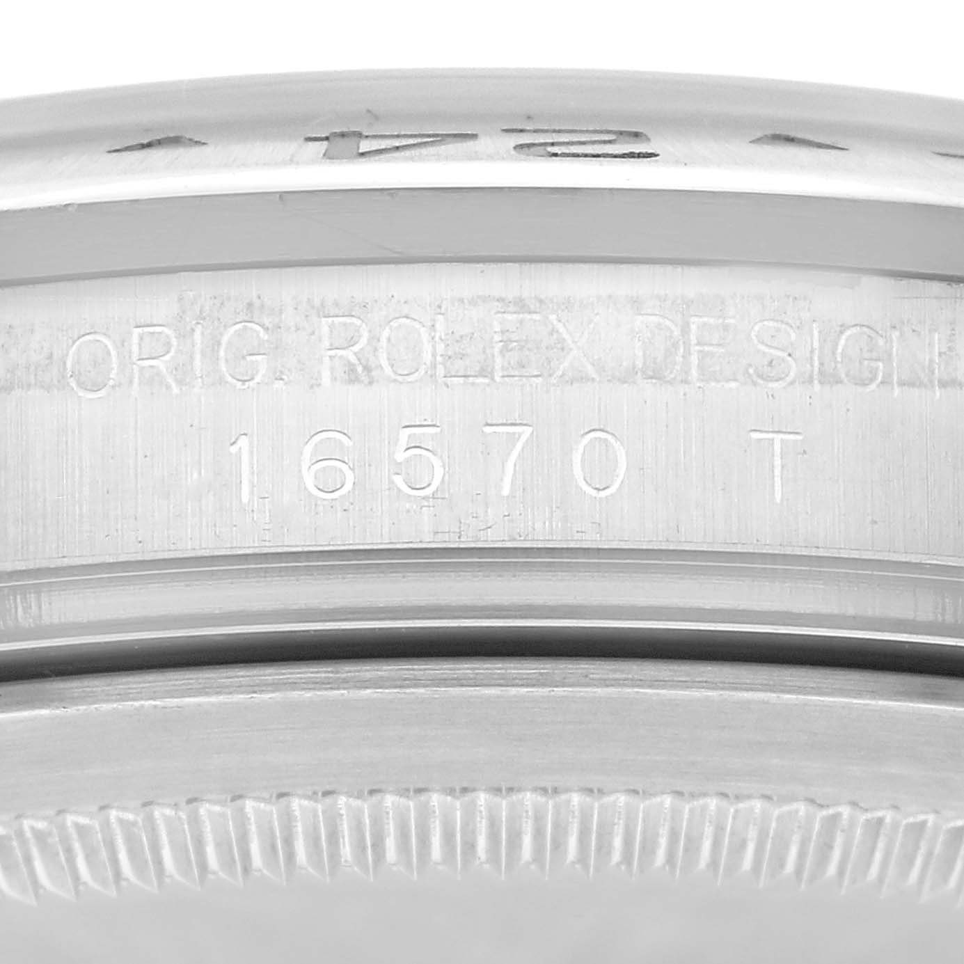 This image shows a close-up view of the side of a Rolex Explorer 16570 Men's Stainless Steel White Dial 16570 Men's Stainless Steel White Dial watch, displaying the model number 16570 T and the "ORIG. ROLEX DESIGN" engraving.