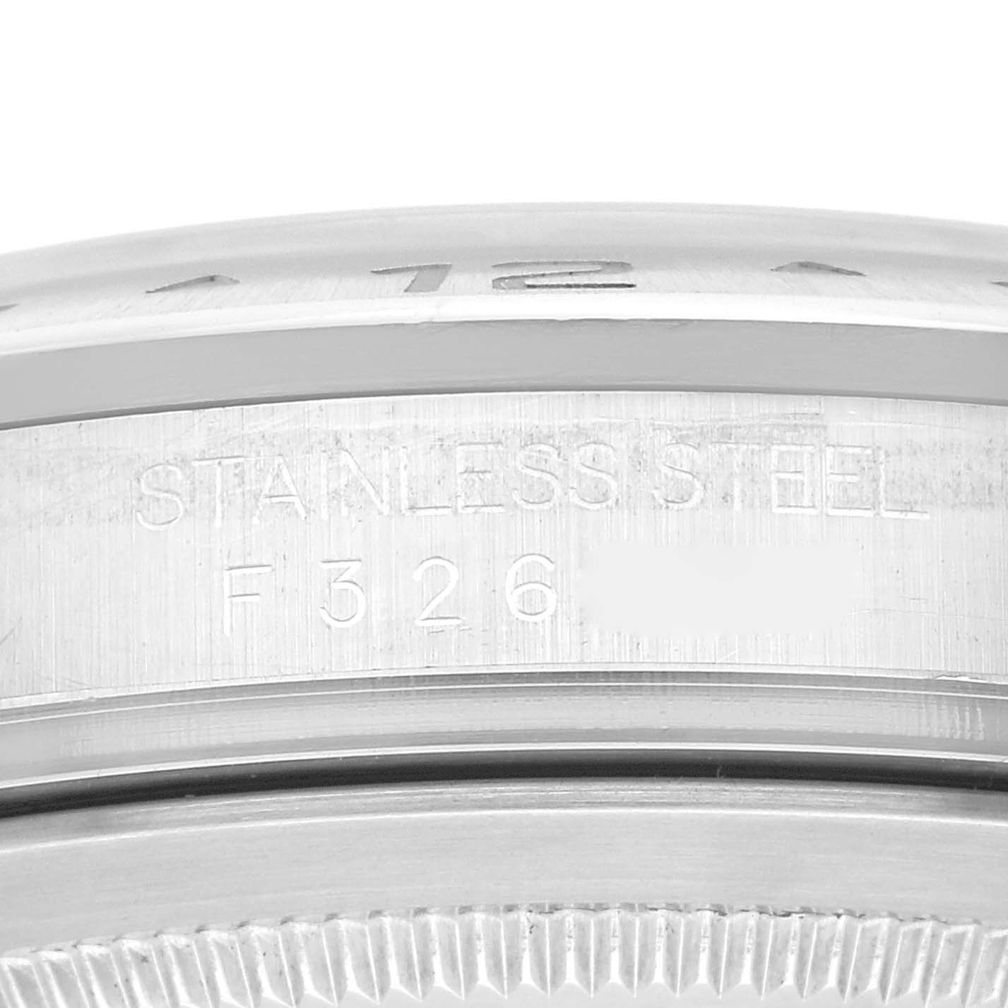 The image shows a close-up view of the side of a Rolex Explorer 16570 Men's Stainless Steel White Dial 16570 Men's Stainless Steel White Dial watch case, featuring the "STAINLESS STEEL" engraving and part of the serial number.