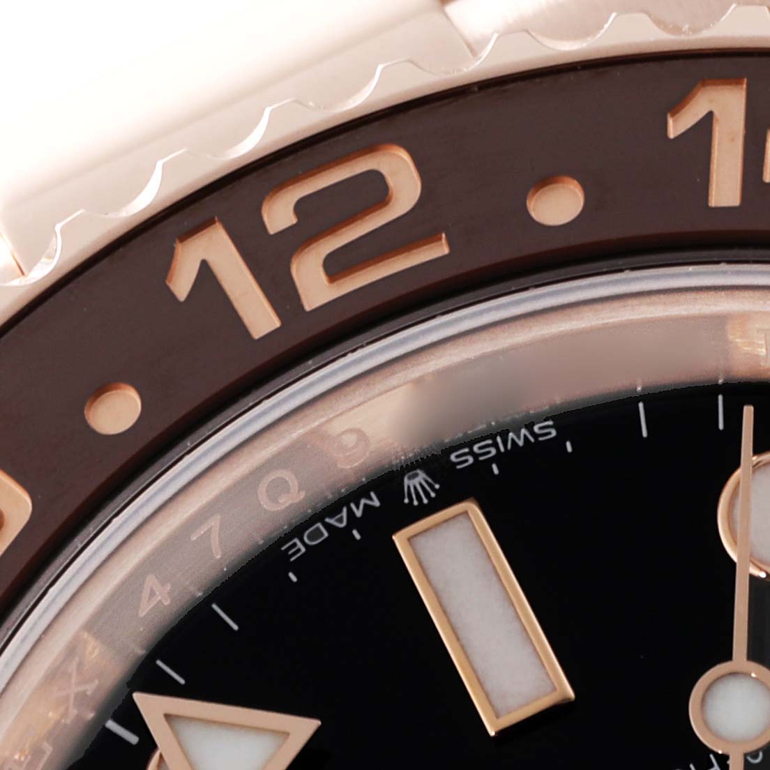 The close-up image shows the bezel and part of the dial of the Rolex GMT-Master 126715CHNR Men's Rose Gold Black Dial 126715CHNR Men's Rose Gold Black Dial watch, highlighting the 12 o'clock marker.