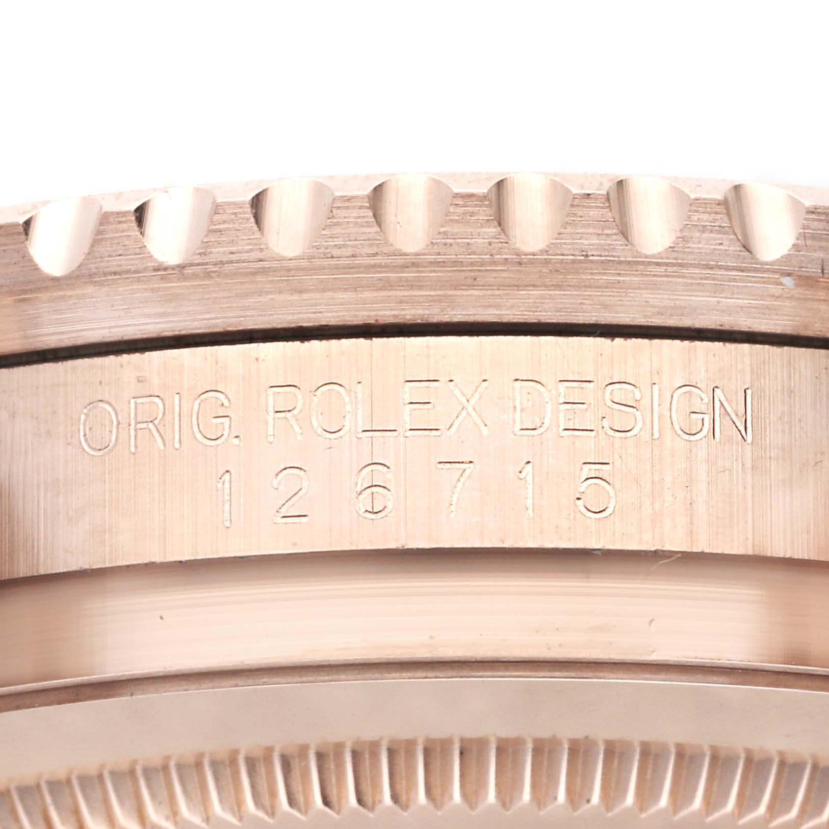 This close-up image depicts the bezel and part of the case of a Rolex GMT-Master 126715CHNR Men's Rose Gold Black Dial 126715CHNR Men's Rose Gold Black Dial watch.