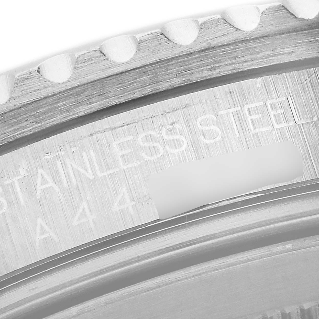 The image shows a close-up of the Rolex GMT-Master 16710 Men
s Stainless Steel Black Dial 16710 Men
s Stainless Steel Black Dial
s stainless steel bezel, displaying part of the model
s engraving.