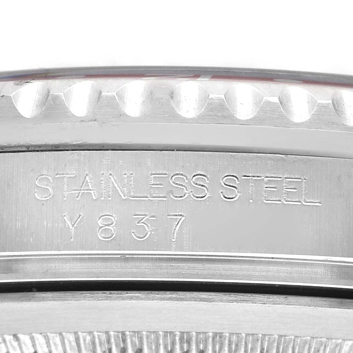 The image shows a close-up of the side of the Rolex GMT-Master 16710 Men
s Stainless Steel Black Dial 16710 Men
s Stainless Steel Black Dial, highlighting the stainless steel material and serial number engraving.