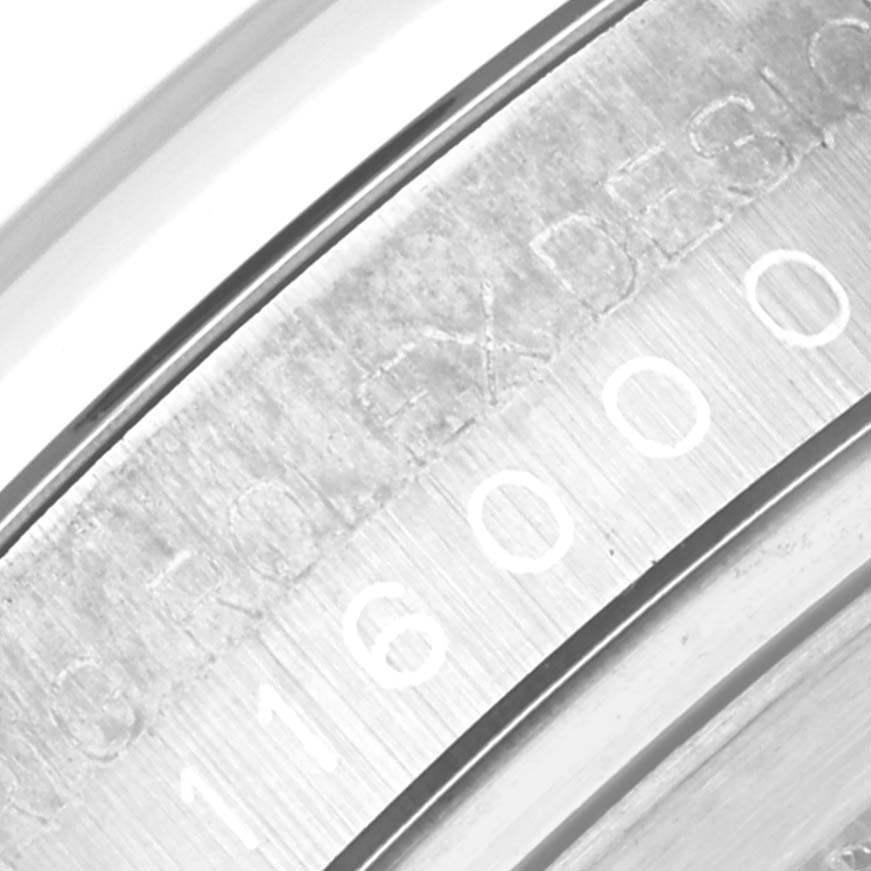 The image shows a close-up of the inner bezel or rehaut of a Rolex Oyster Perpetual 116000 Men
s Stainless Steel Blue Dial 116000 Men
s Stainless Steel Blue Dial watch, displaying the engraved model number.