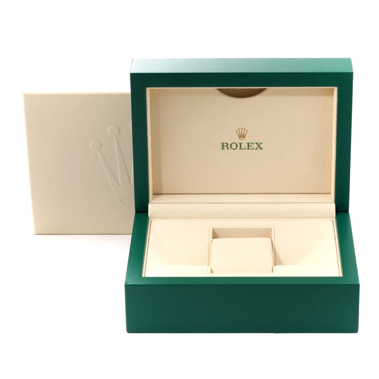 The image shows an open green and beige Rolex box, presumably for the Oyster Perpetual model, with the Rolex logo inside.