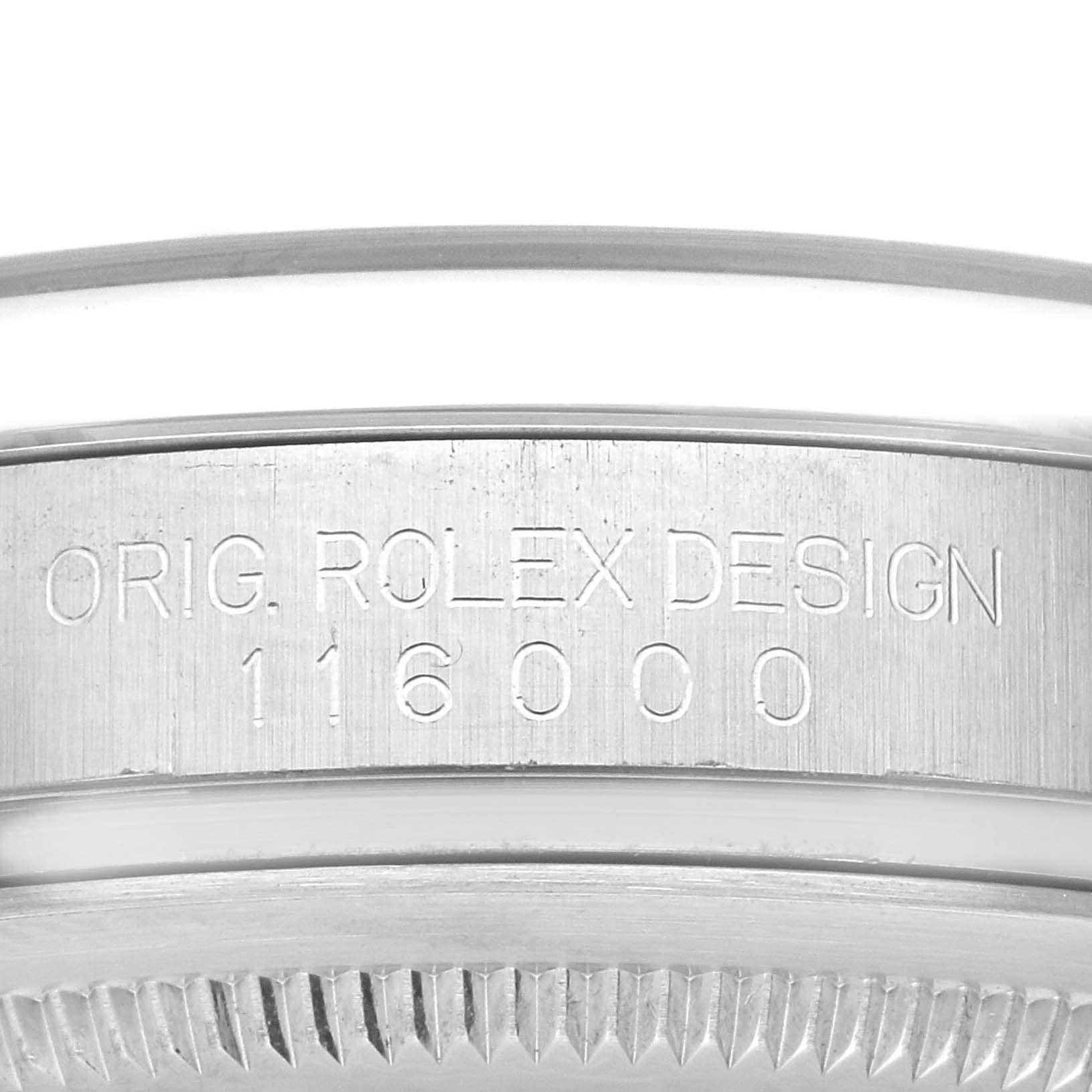 This image shows a close-up of the engraved side of the Rolex Oyster Perpetual 116000 Men
s Stainless Steel Blue Dial 116000 Men
s Stainless Steel Blue Dial watch case, displaying "ORIG. ROLEX DESIGN 116000."