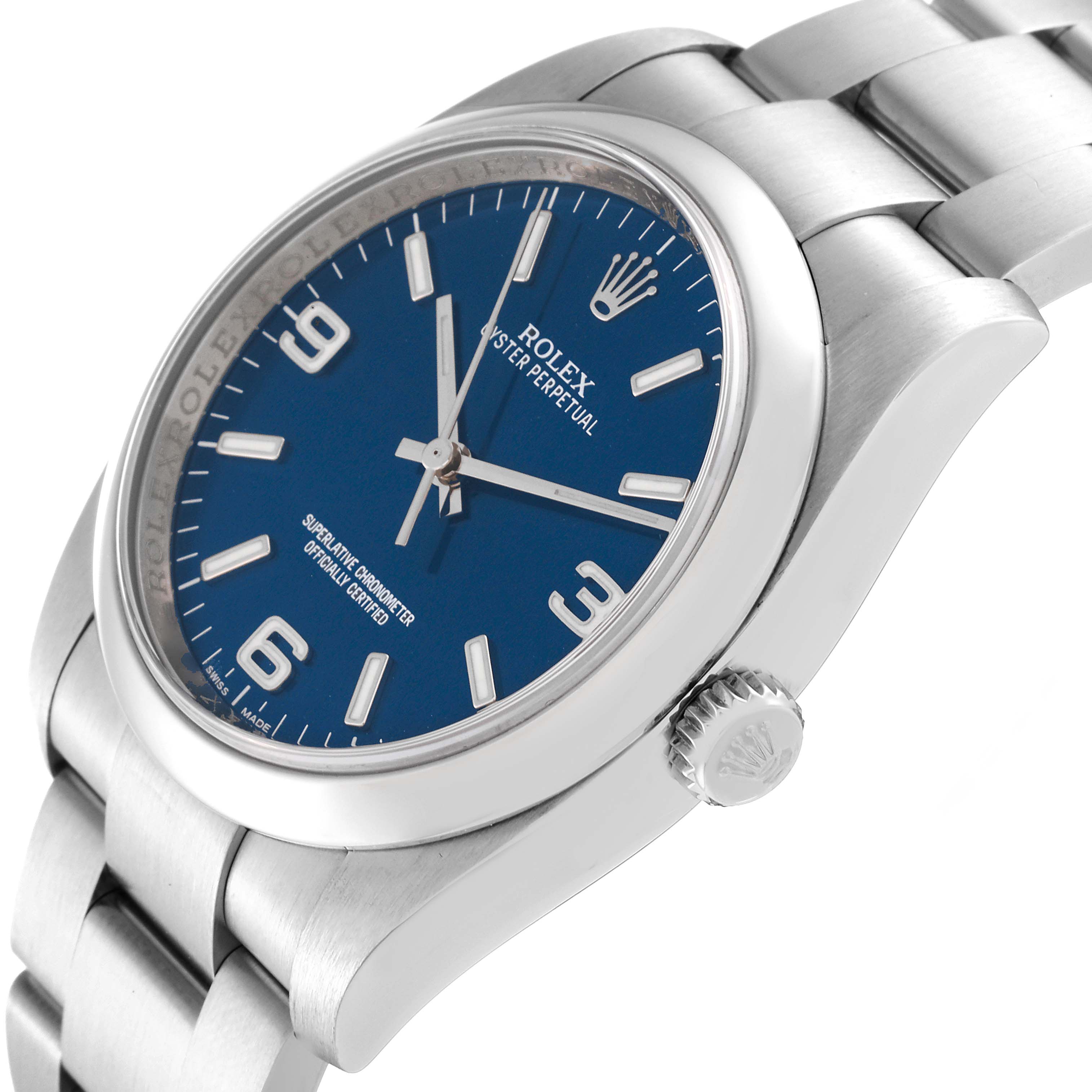 The image shows a close-up angle of a Rolex Oyster Perpetual 116000 Men
s Stainless Steel Blue Dial 116000 Men
s Stainless Steel Blue Dial watch, highlighting the blue dial, bezel, crown, and part of the bracelet.