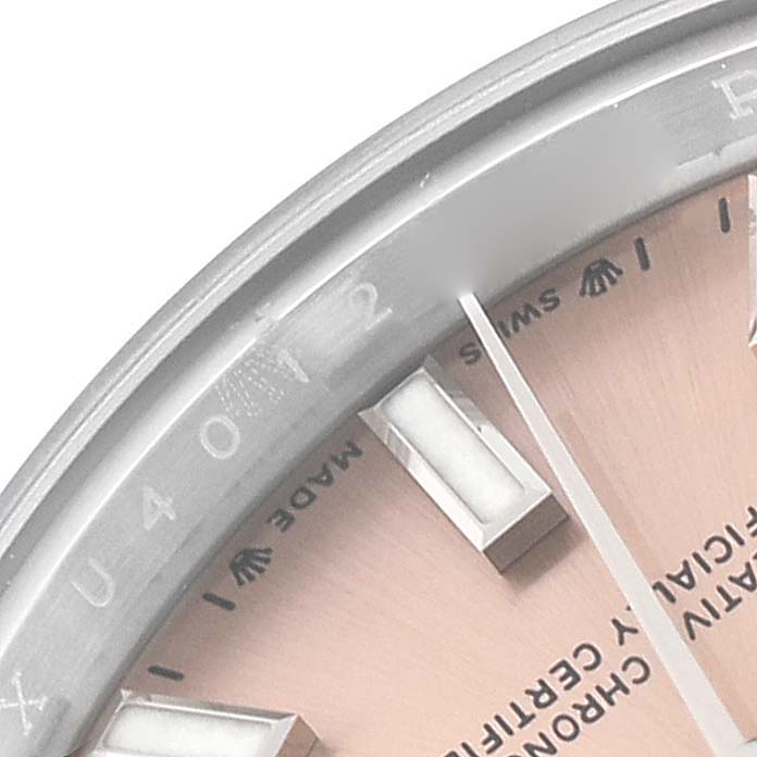 The image shows a close-up of the bezel, hour markers, and part of the dial of a Rolex Oyster Perpetual 276200 Women's Stainless Steel Pink Dial 276200 Women's Stainless Steel Pink Dial watch.