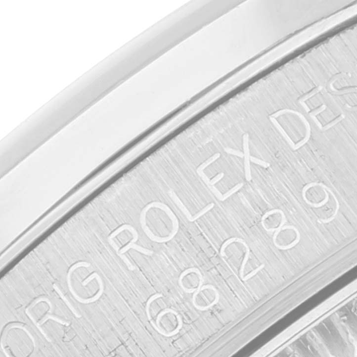 This close-up shot shows the engraving on the inner bezel of a Rolex President 68289 Women's White Gold Silver Dial 68289 Women's White Gold Silver Dial model watch.
