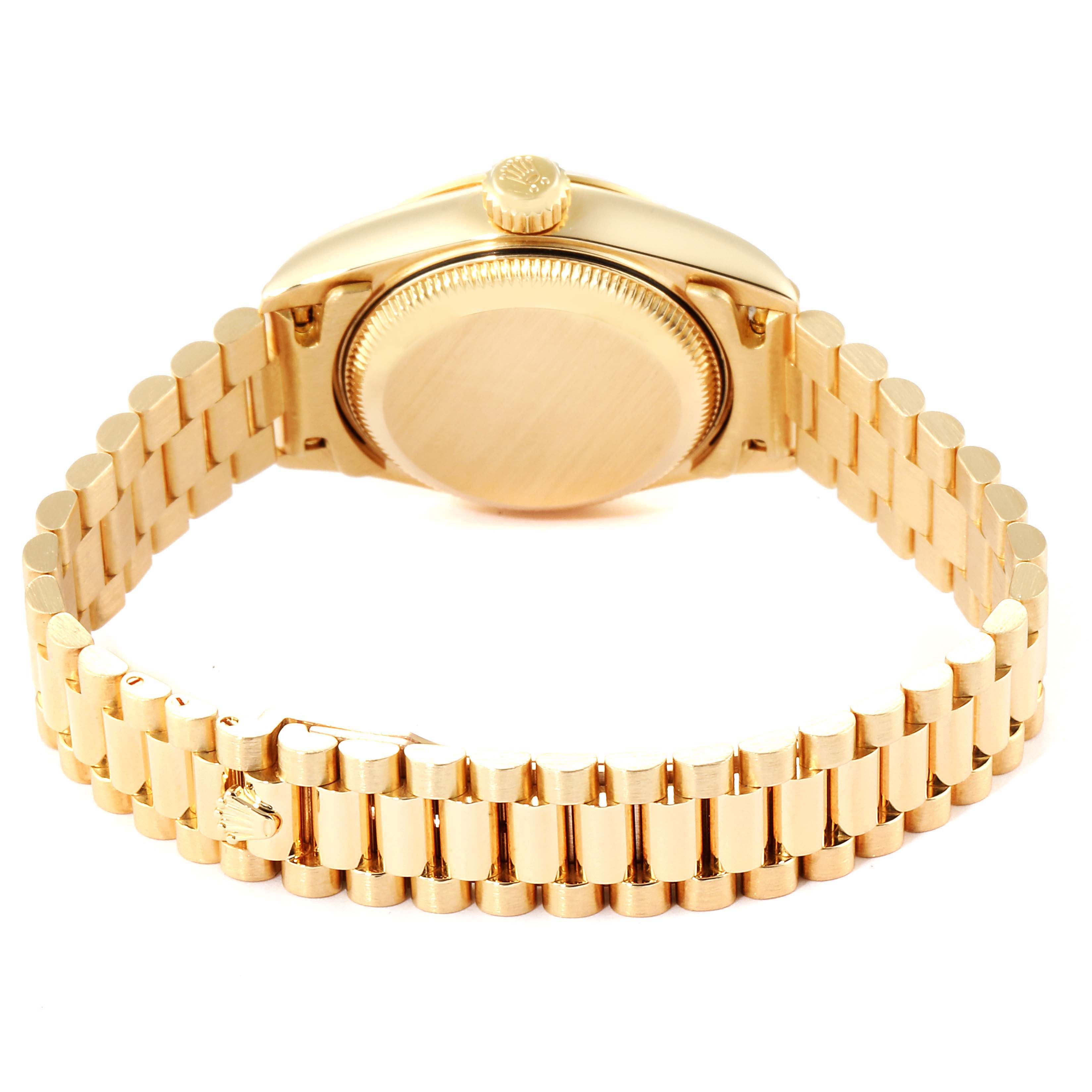 The image shows the underside of the Rolex President 79168 Women
s Yellow Gold Mother of Pearl Dial 79168 Women
s Yellow Gold Mother of Pearl Dial model watch, highlighting the bracelet and case back.