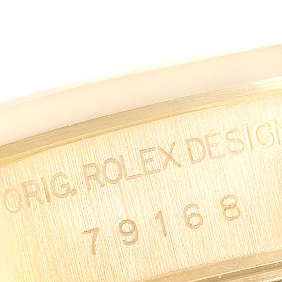 The image shows a close-up of the engraved serial number and "ORIG. ROLEX DESIGN" on the Rolex President 79168 Women
s Yellow Gold Mother of Pearl Dial 79168 Women
s Yellow Gold Mother of Pearl Dial model watch.