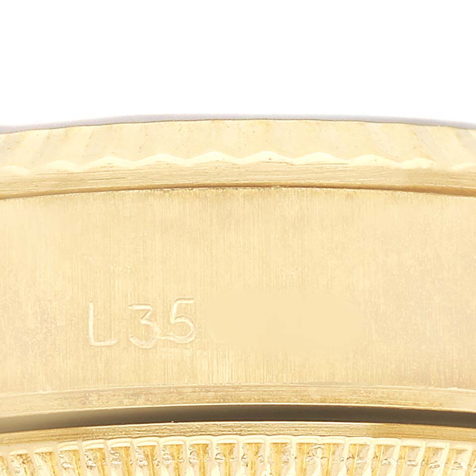The image shows a close-up of the side of the bezel and part of the fluted design of a Rolex Datejust 69178 Women's Yellow Gold Champagne Dial watch.