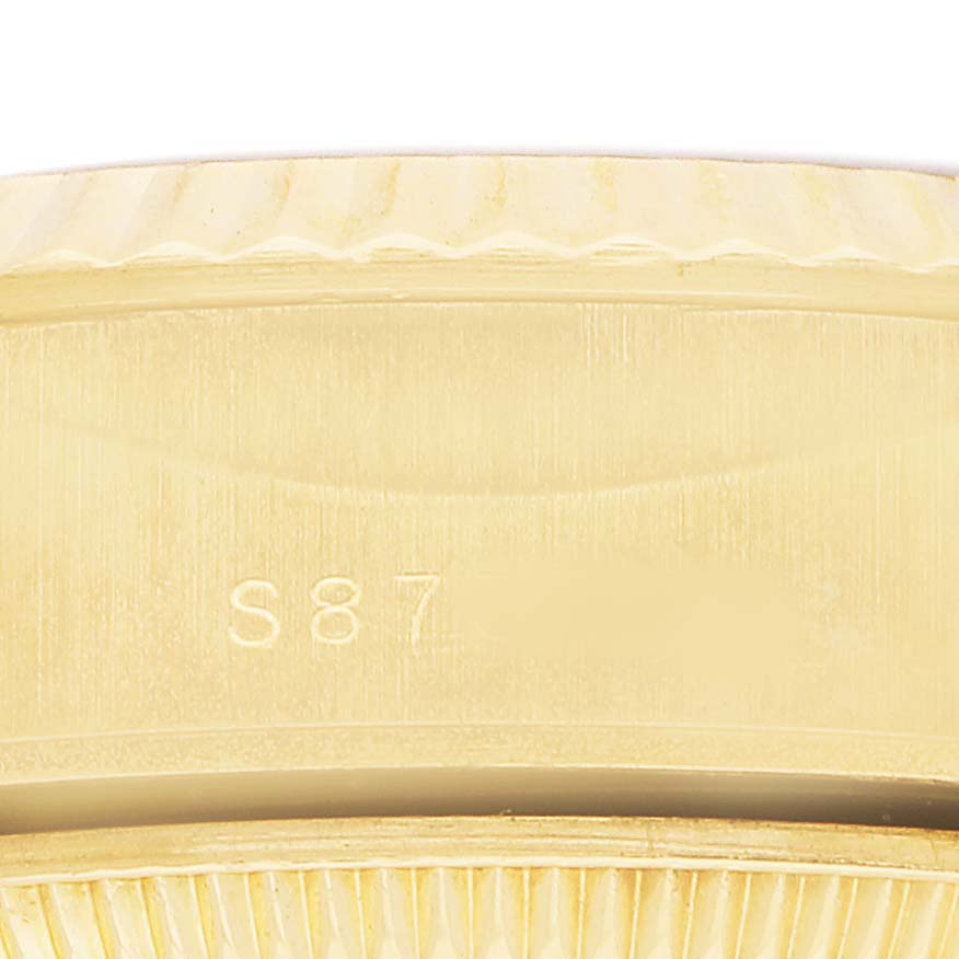 The image shows a close-up of the side of a Rolex President 69178 Women's Yellow Gold Champagne Dial watch, highlighting the bezel and engraved markings.