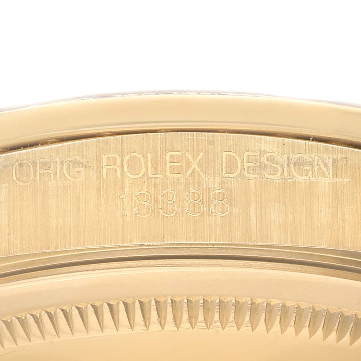 This close-up shows the engraved serial number and part of the fluted bezel on the Rolex President 18388 Men
s Yellow Gold Champagne Dial 18388 Men
s Yellow Gold Champagne Dial model watch.