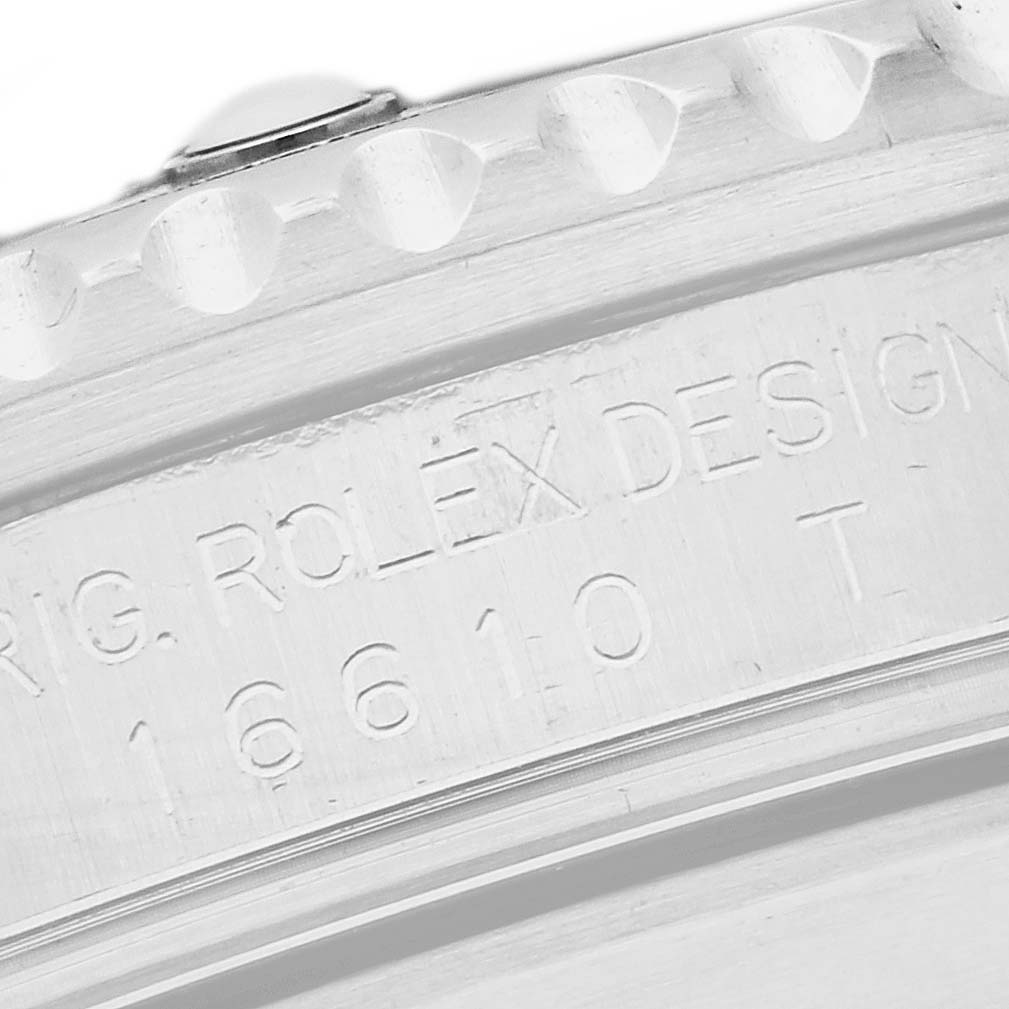 The image shows an angled close-up of the side of the Rolex Submariner 16610 Men
s Stainless Steel Black Dial 16610 Men
s Stainless Steel Black Dial, highlighting the engraved model number and design markings.