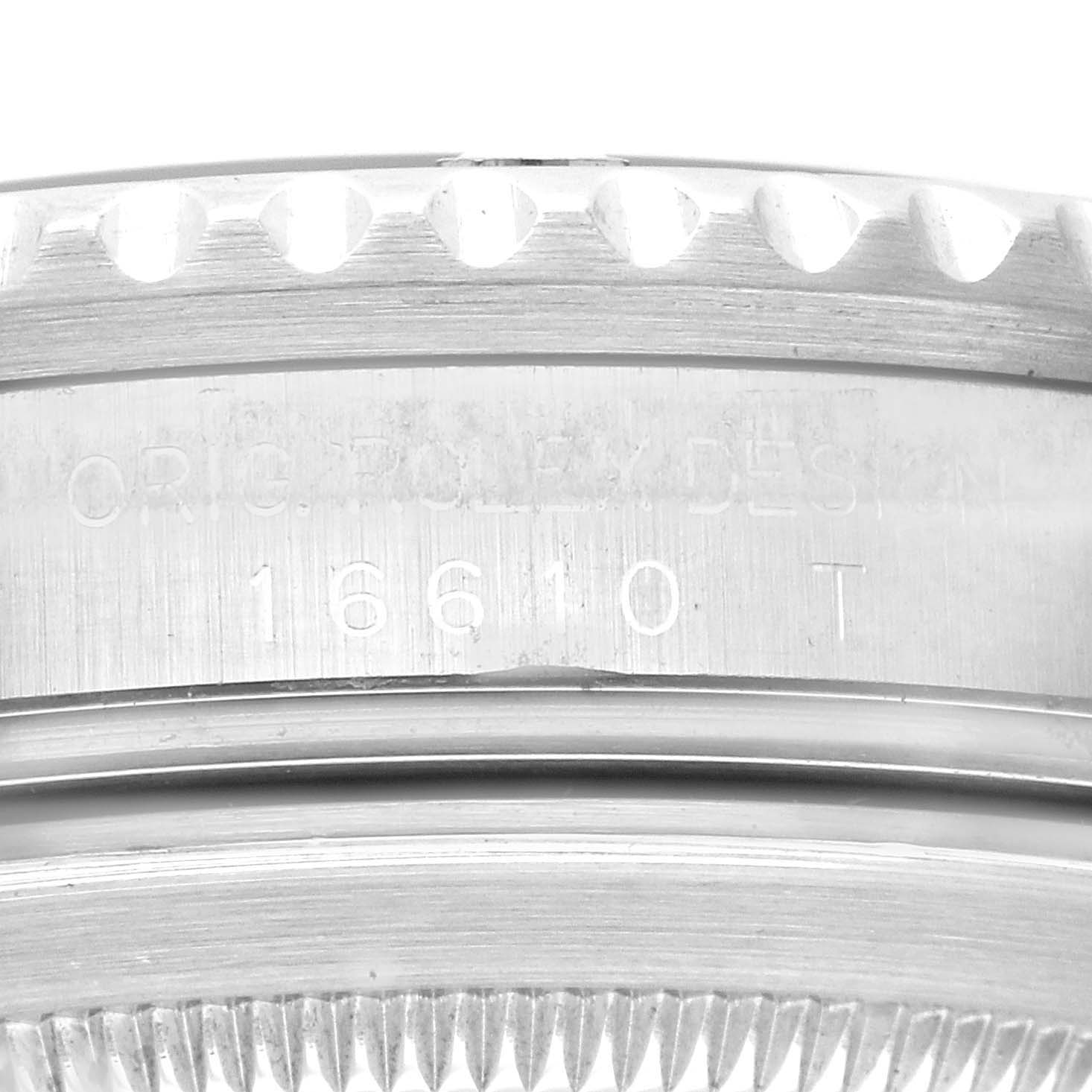 This image shows a close-up of the engraved bezel and serial number area of a Rolex Submariner 16610 Men
s Stainless Steel Black Dial 16610 Men
s Stainless Steel Black Dial watch.