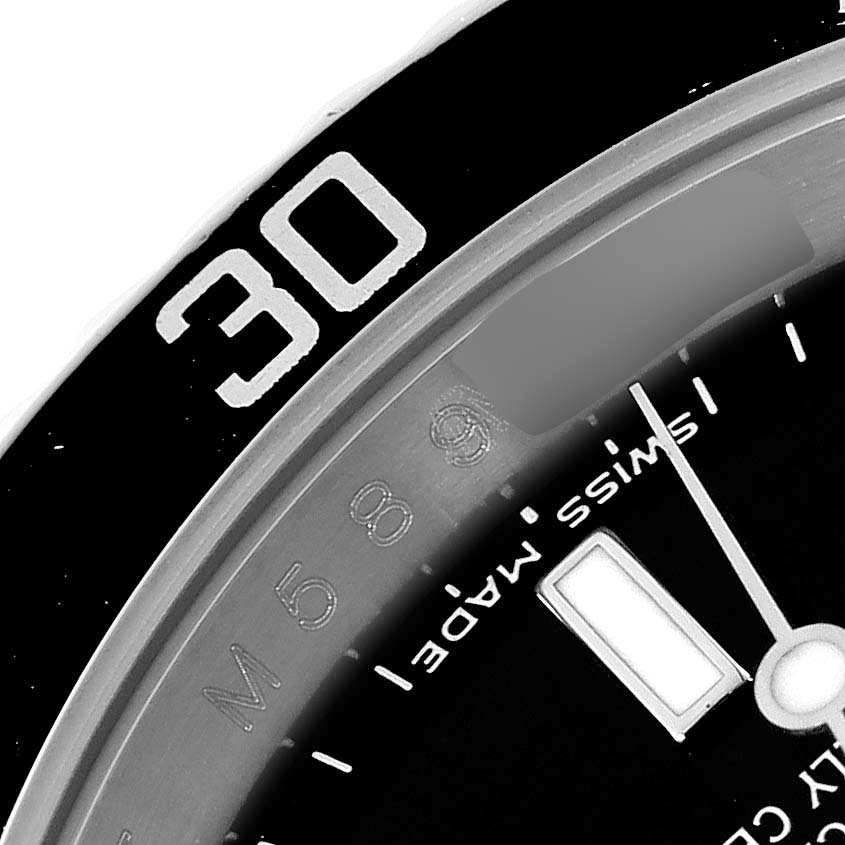 This image shows a close-up of the bezel and part of the dial of a Rolex Submariner 16610 Men
s Stainless Steel Black Dial 16610 Men
s Stainless Steel Black Dial watch, featuring the “30” minute marker and "Swiss Made."