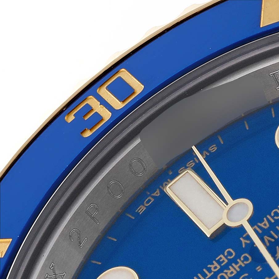 The image shows a close-up view of the bezel and part of the dial of a Rolex Submariner 116613LB Men's Steel and Gold (two tone) Blue Dial 116613LB Men's Steel and Gold (two tone) Blue Dial watch.
