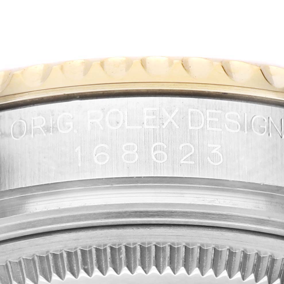 The image shows a close-up of the side of a Rolex Yacht-Master 168623 Men's Steel and Gold (two tone) Champagne Dial watch, focusing on the bezel and model number.