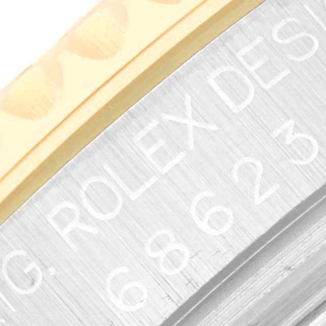 This close-up image features the engraved bezel and case of a Rolex Yacht-Master 68623 Men's Steel and Gold (two tone) White Dial 68623 Men's Steel and Gold (two tone) White Dial watch.
