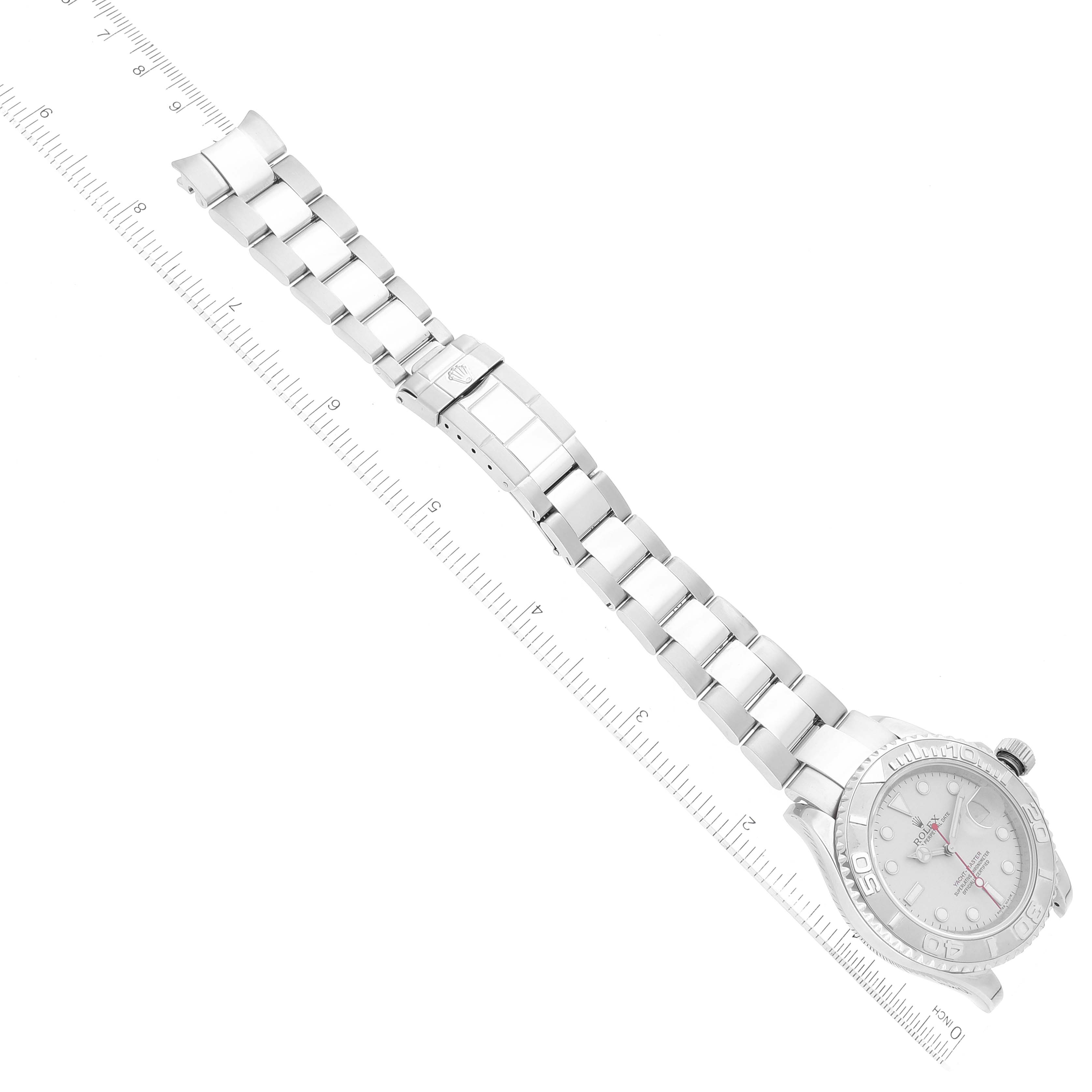 The image shows the full length of the Rolex Yacht-Master 16622 Men
s Stainless Steel Silver Dial 16622 Men
s Stainless Steel Silver Dial watch, including its case, dial, and metal bracelet, laid flat with a ruler for scale.
