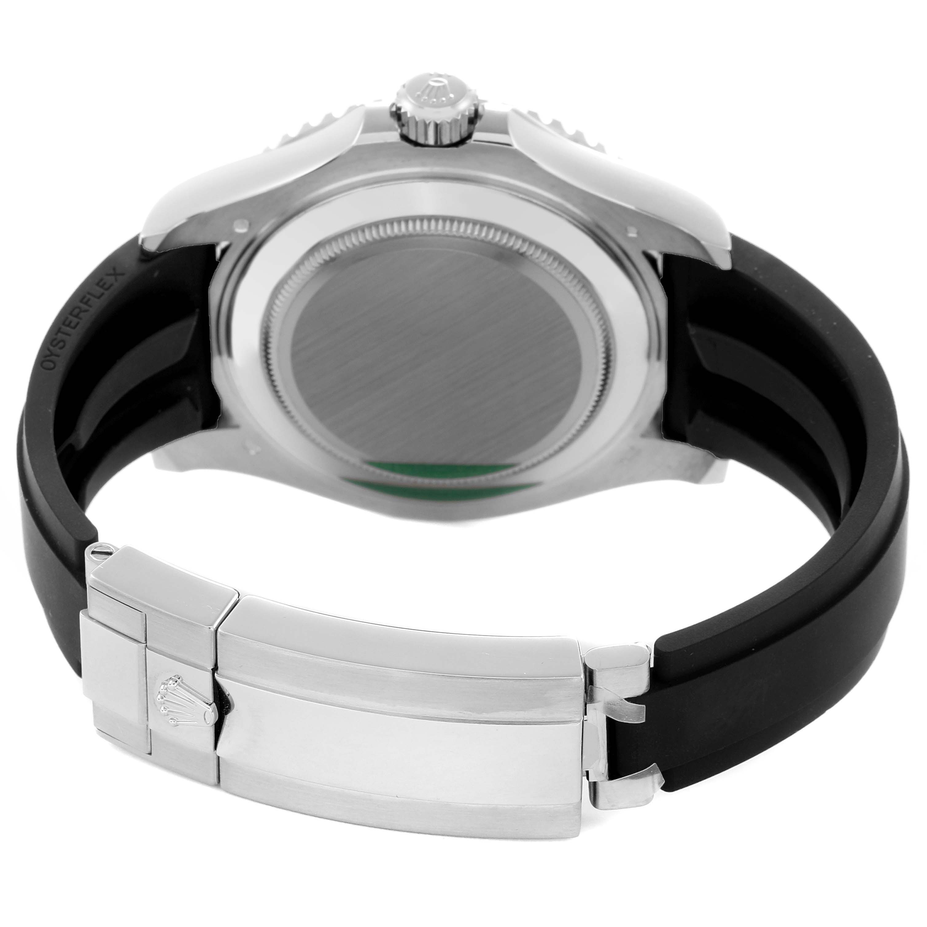 The image shows the back side view of a Rolex Yacht-Master 226659 Men
s White Gold Black Dial 226659 Men
s White Gold Black Dial with a focus on the case back, crown, and rubber strap with a clasp.