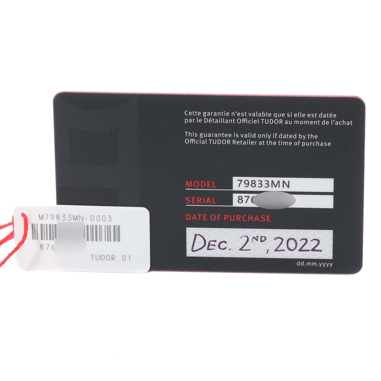 This image shows the warranty card and tag for the Tudor Heritage Black Bay 79833MN Men's Stainless Steel Black Dial 79833MN Men's Stainless Steel Black Dial watch, model 79833MN, dated December 2nd, 2022.