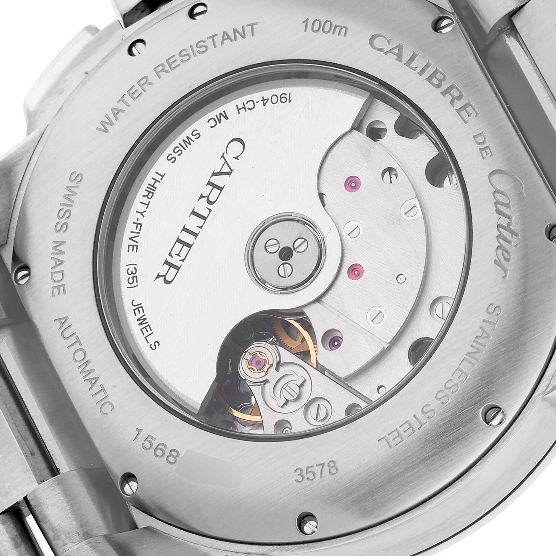 The image shows the back case of the Calibre de Cartier watch, highlighting the movement and inscription details.