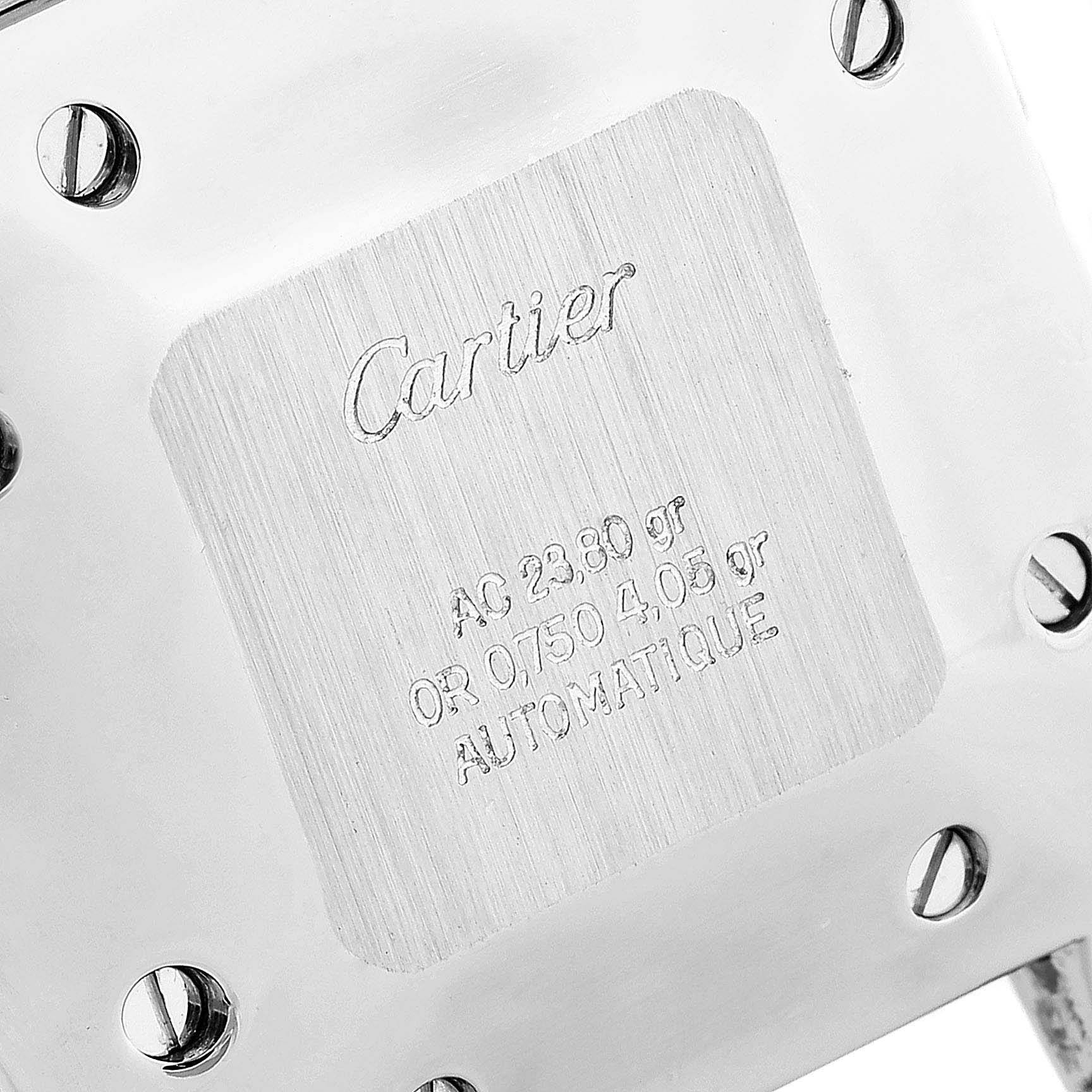 The image shows the back of a Santos model watch by Cartier, highlighting its engraved specifications and screws.