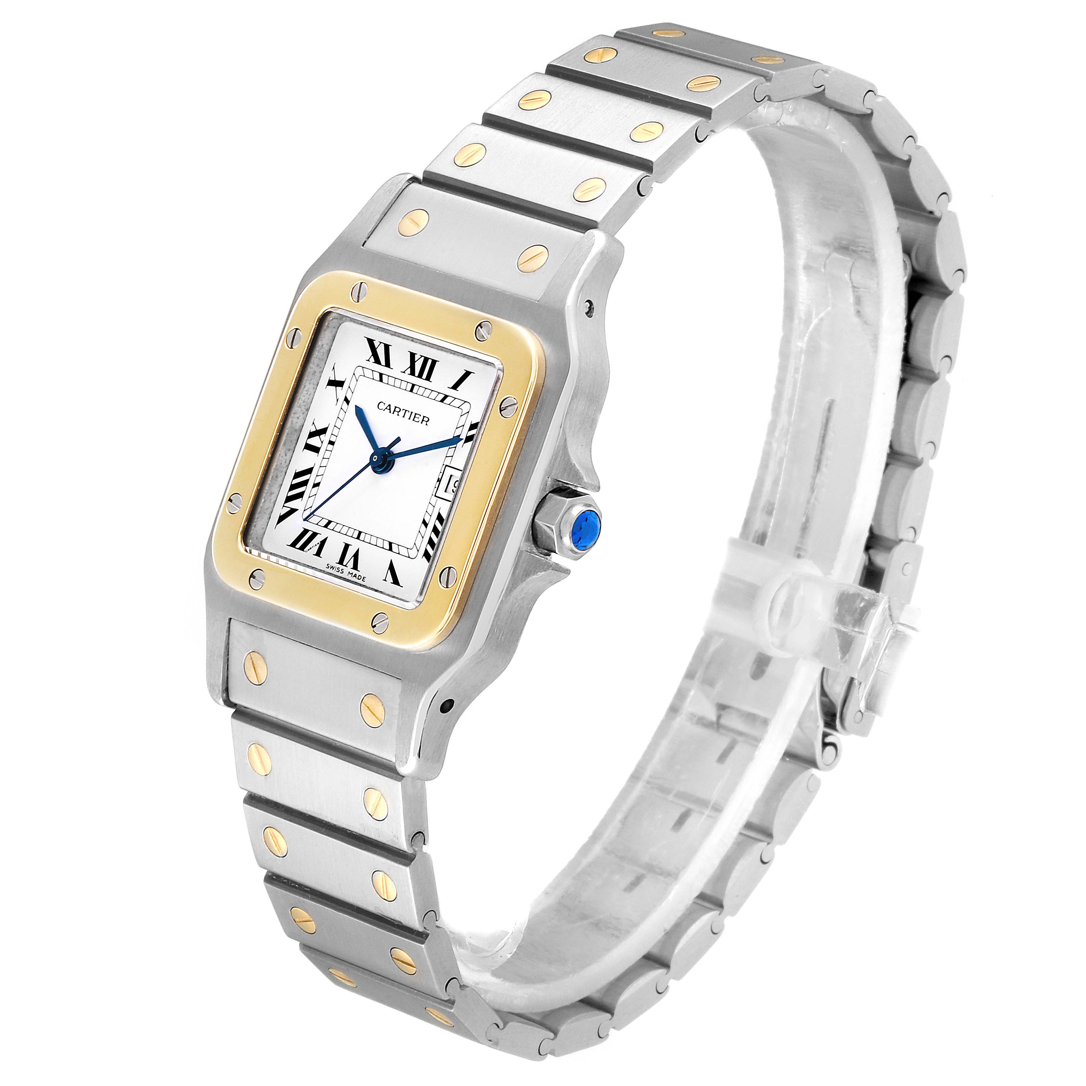 The image shows a Cartier Santos 187901 Men's Steel and Gold (two tone) White Dial 187901 Men's Steel and Gold (two tone) White Dial watch viewed from a three-quarter angle, highlighting its face, bezel, and bracelet.