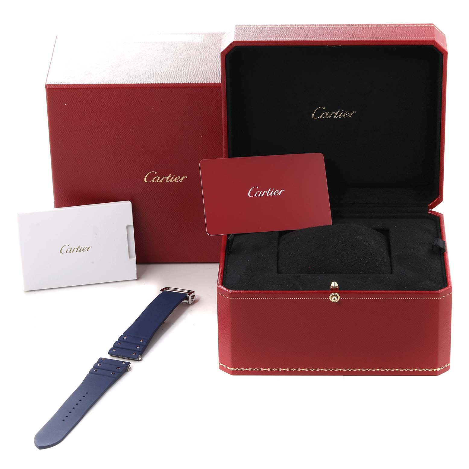 The image shows a Santos model Cartier watch box with a watch strap and accessories at an oblique angle.
