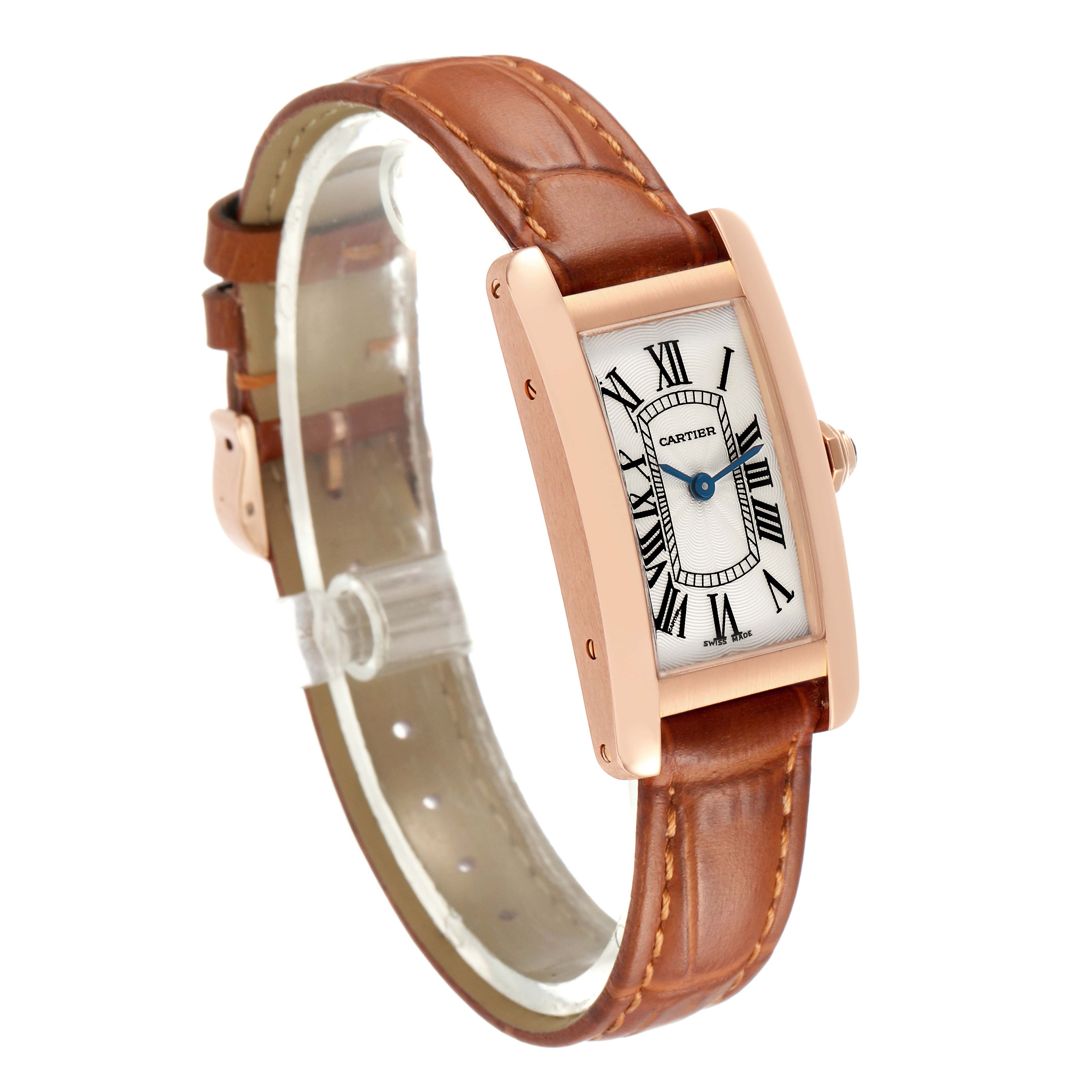 The Cartier Tank Americaine W2607456 Women's Rose Gold White Dial watch is shown at a three-quarter angle, highlighting the rectangular case, white dial, and brown leather strap.
