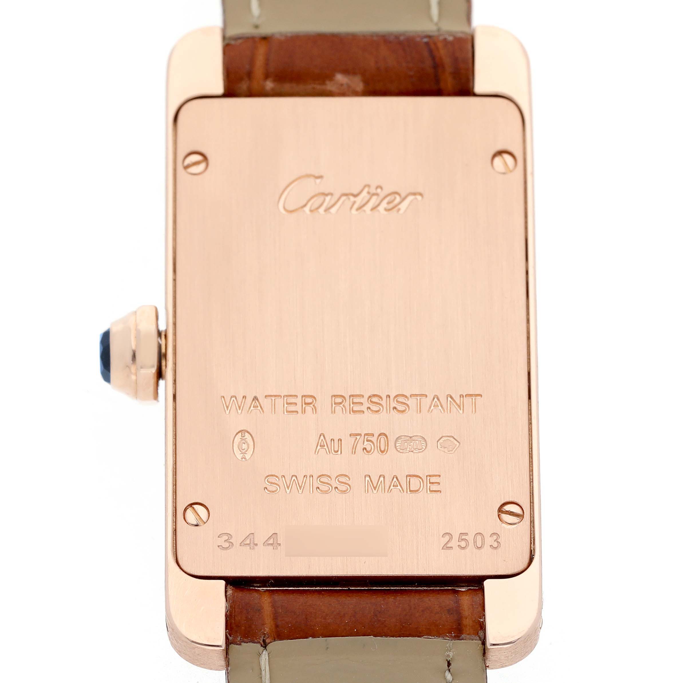 The image shows the back of a Cartier Tank Americaine W2607456 Women's Rose Gold White Dial watch, highlighting engravings and a brown leather strap.