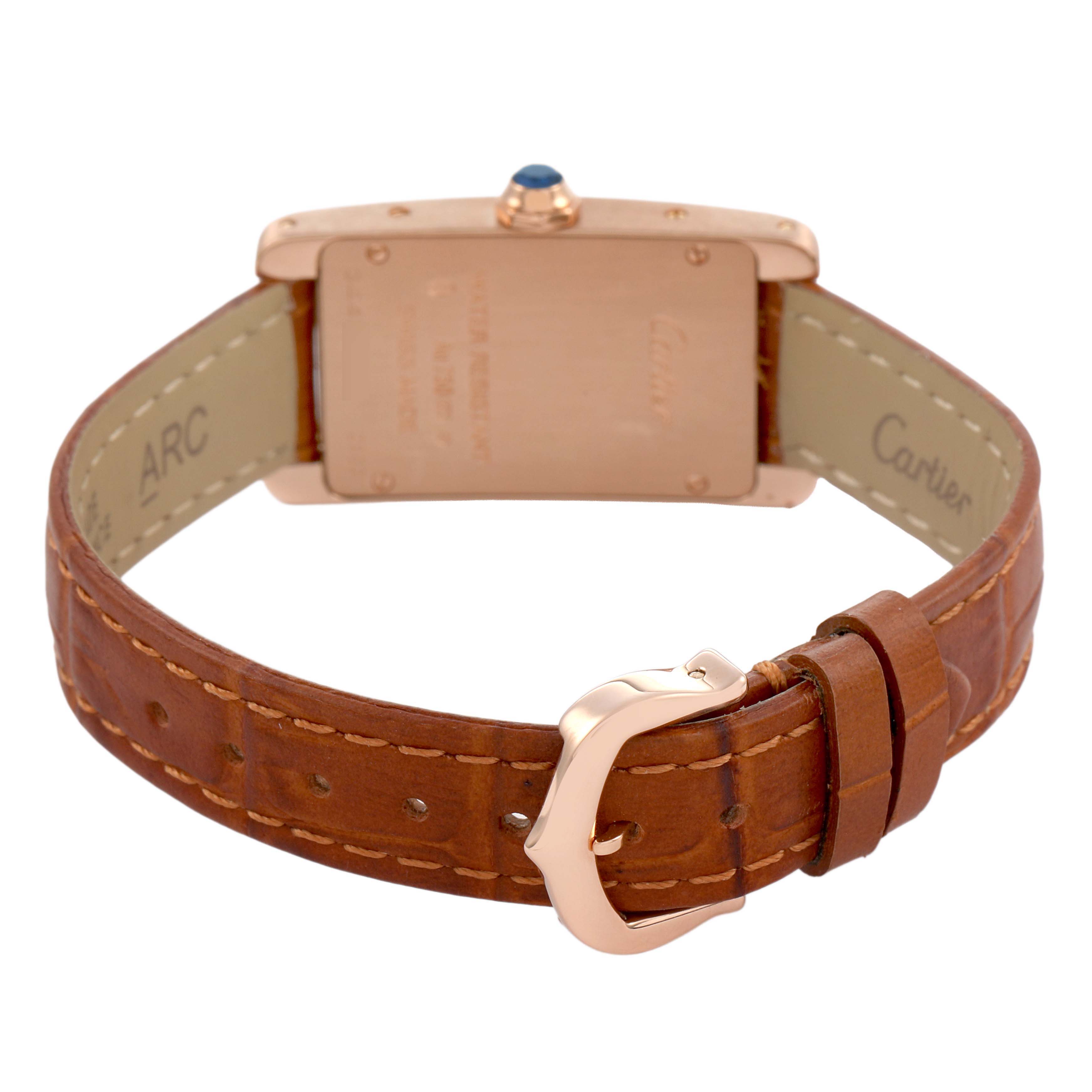 The Cartier Tank Américaine watch is shown from the back, highlighting the case, leather strap, and buckle.