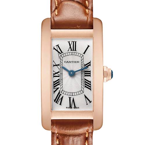 The Cartier Tank Américaine watch is shown from the front, displaying the dial, brown leather strap, and crown with a blue cabochon.