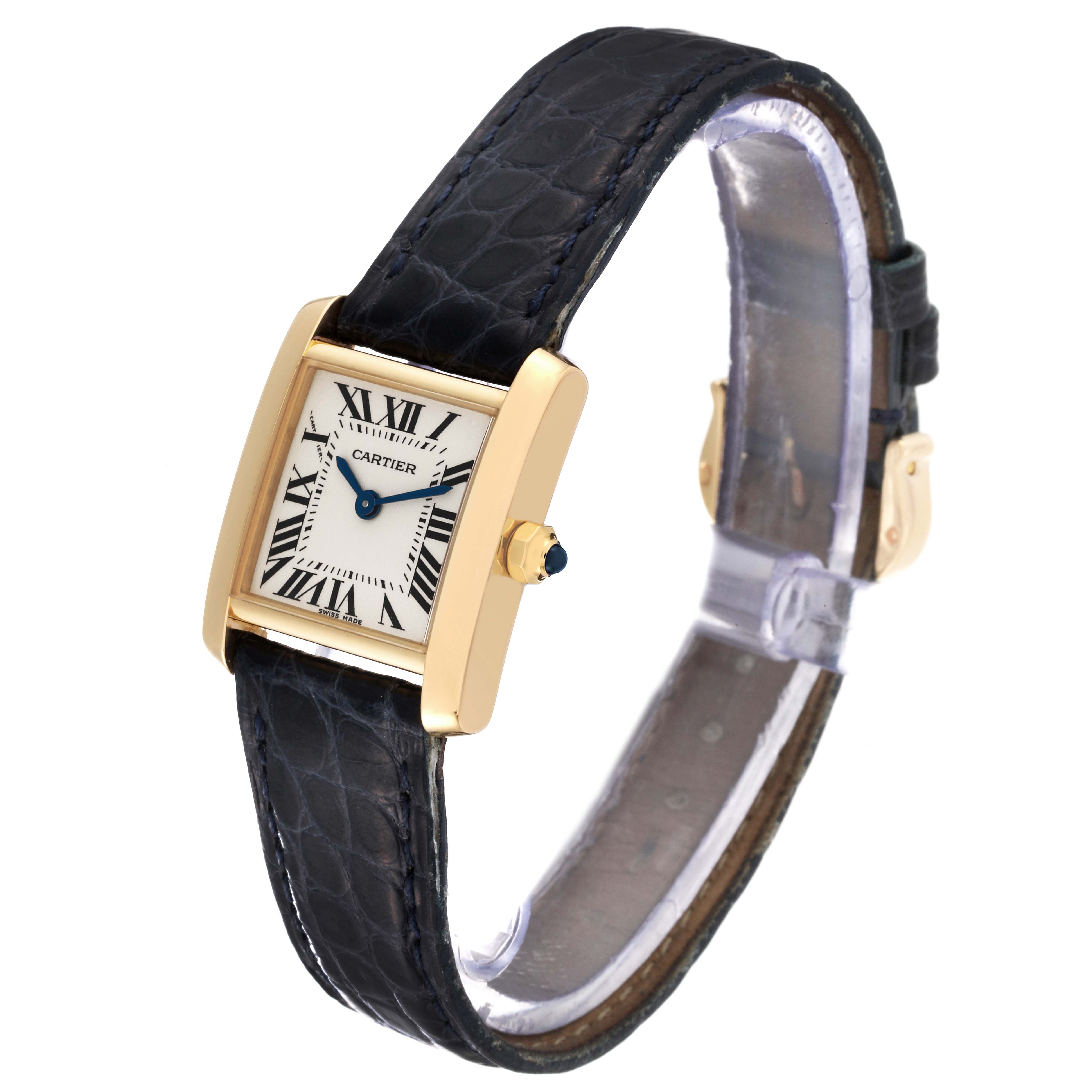The Cartier Tank Francaise W5000256 Women
s Yellow Gold Silver Dial W5000256 Women
s Yellow Gold Silver Dial watch is shown at a slight angle, highlighting its leather strap, square dial, and gold casing.