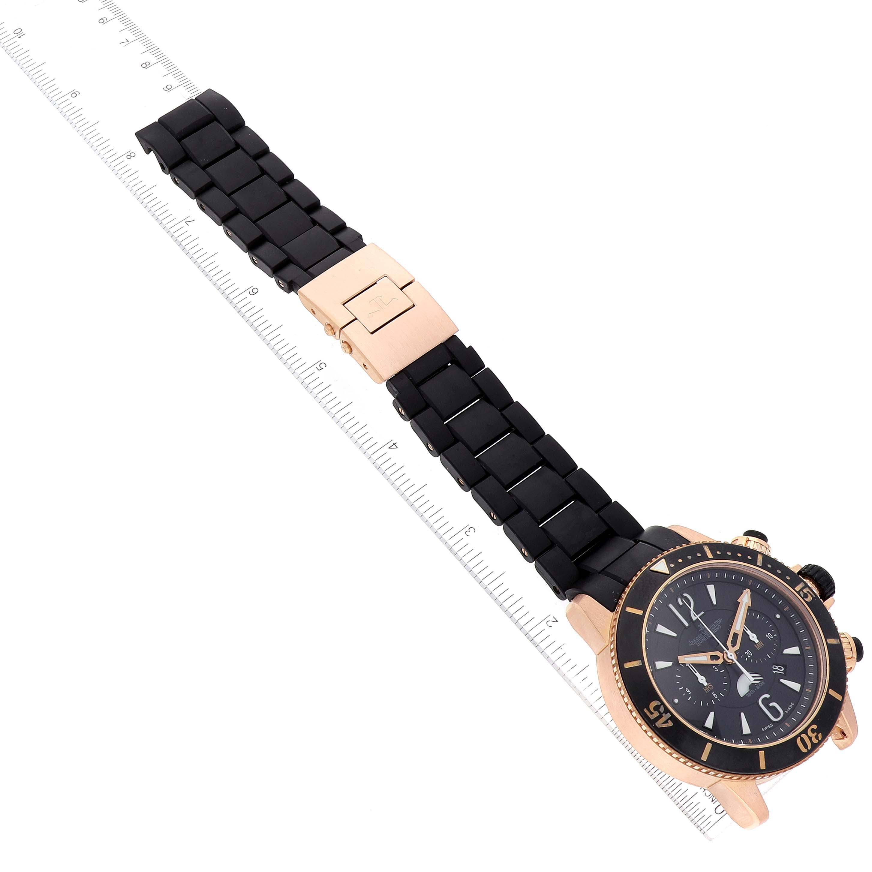 This image shows a Jaeger-LeCoultre Master model watch laid flat with a black band and gold clasp, next to a ruler for scale.