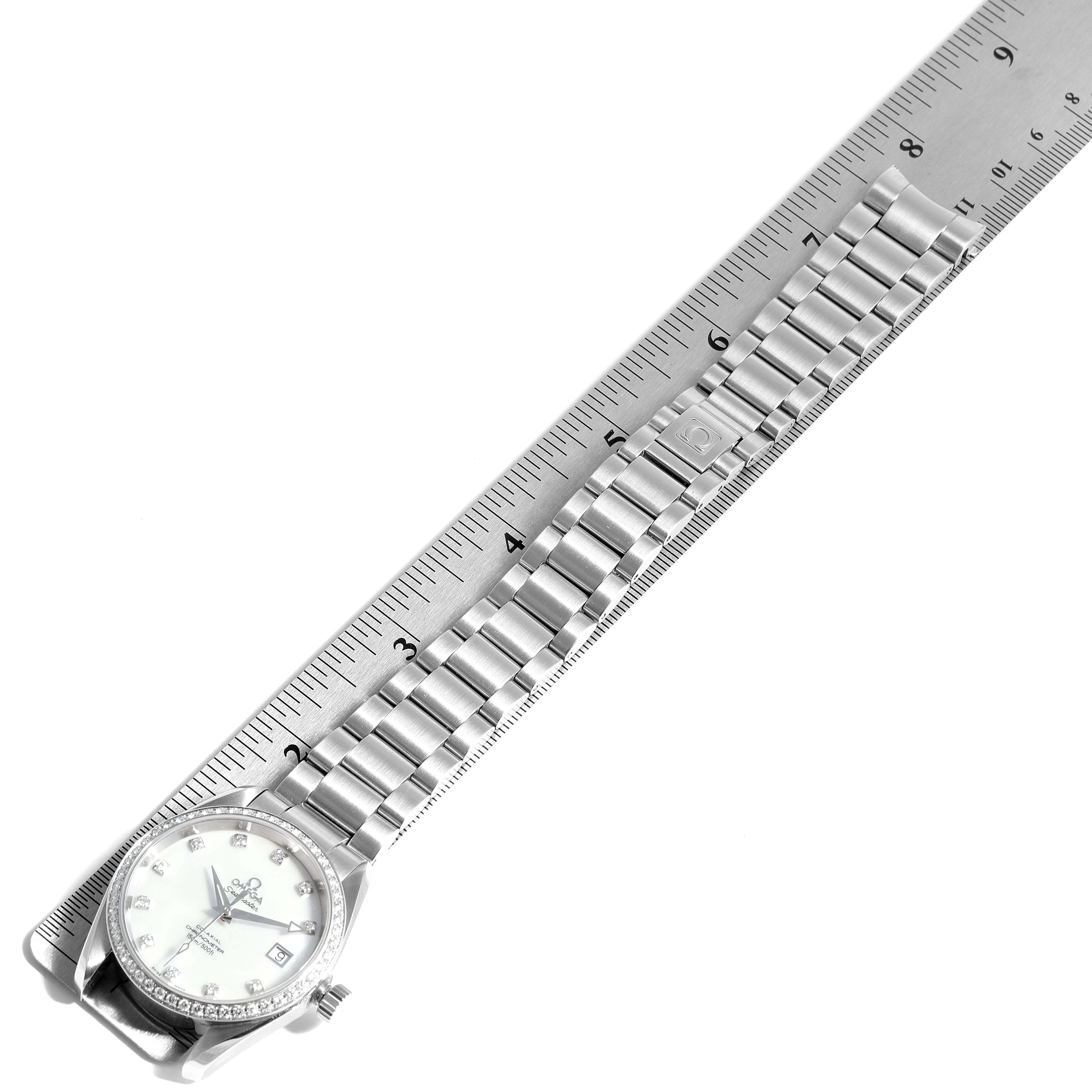 The image shows the Omega 2509.75.00 Women's Stainless Steel Mother of Pearl Dial 2509.75.00 Women's Stainless Steel Mother of Pearl Dial Aqua Terra 36 Steel MOP Diamond Ladies Watch 2509.75.00 from a top-down angle, with a ruler measuring its bracelet.