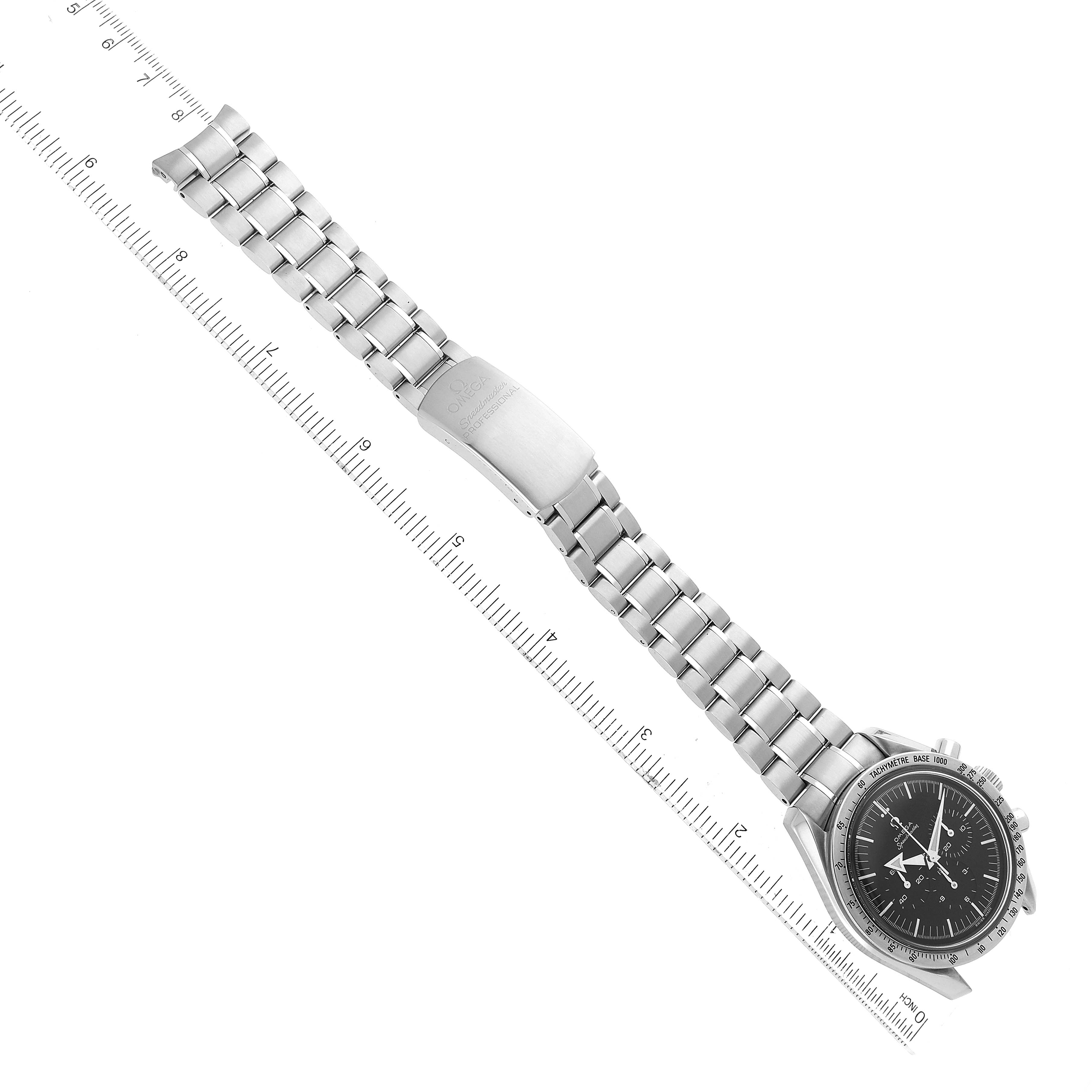 The image shows a full view of the Omega Speedmaster 3594.50.00 Men
s Stainless Steel Black Dial 3594.50.00 Men
s Stainless Steel Black Dial watch laid flat, face-up with a ruler for scale.