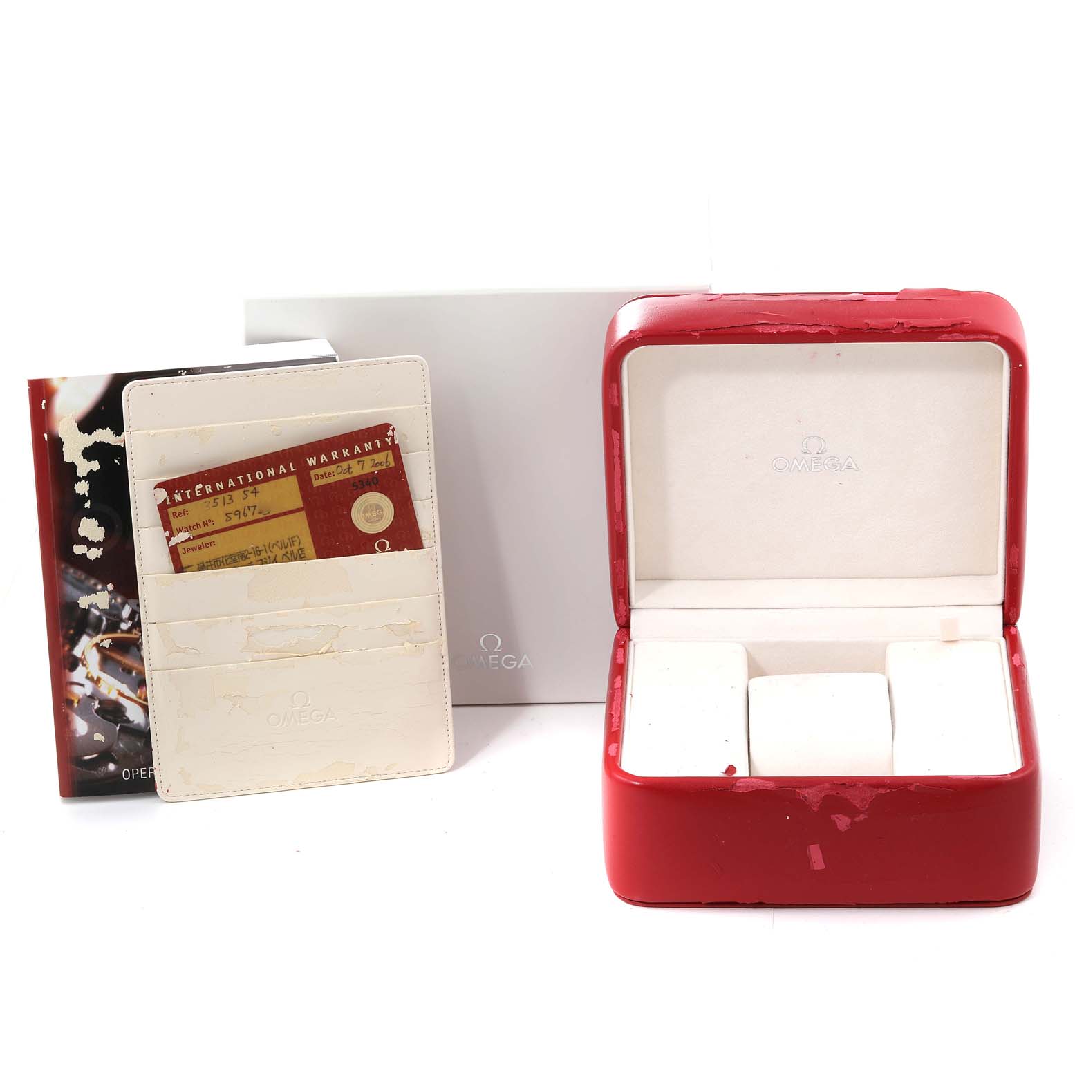 The image shows a red Omega Speedmaster 3513.54.00 Men
s Stainless Steel Black Dial 3513.54.00 Men
s Stainless Steel Black Dial watch box with warranty cards and a booklet from a front angle.