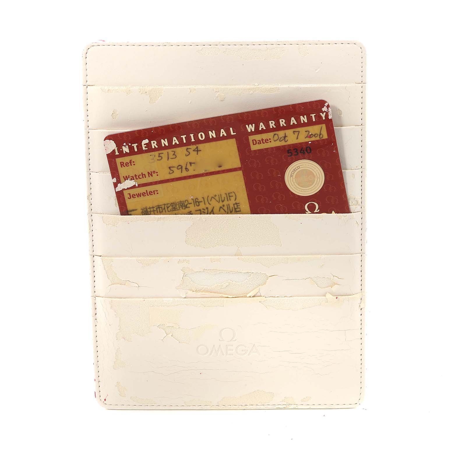 This image shows an Omega Speedmaster 3513.54.00 Men
s Stainless Steel Black Dial 3513.54.00 Men
s Stainless Steel Black Dial international warranty card inside a white cardholder.