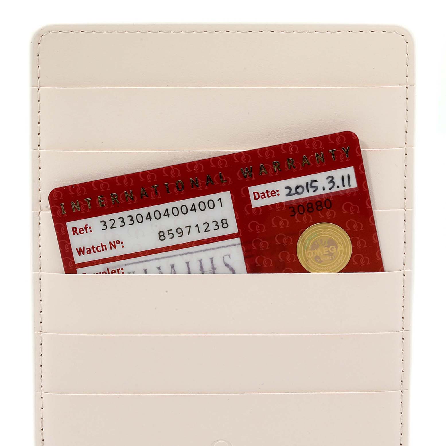 The image shows an Omega Speedmaster 323.30.40.40.04.001 Men's Stainless Steel White Dial 323.30.40.40.04.001 Men's Stainless Steel White Dial warranty card in a beige cardholder, viewed from the front.