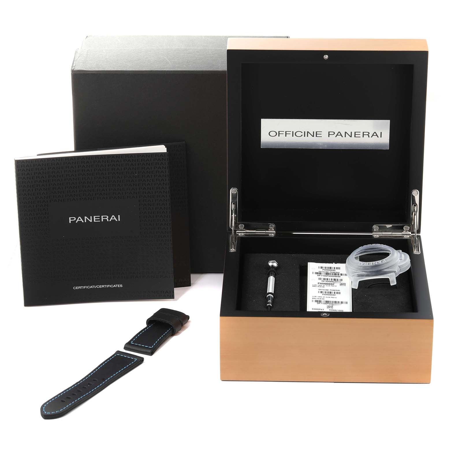 The image shows a Panerai Submersible PAM00692 Men's Stainless Steel Blue Dial PAM00692 Men's Stainless Steel Blue Dial watch box set, including manuals, a strap, a tool, and official documentation.