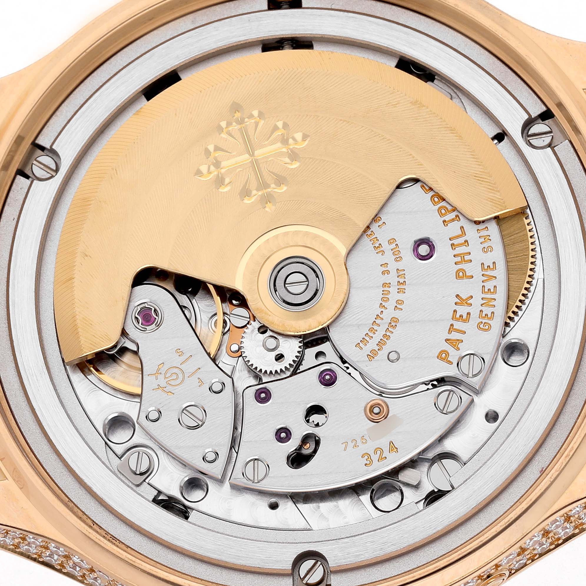 The image shows the intricate movement of a Patek Philippe Complications 4948R-001 Women's Rose Gold Mother of Pearl Dial watch, viewed from the back, highlighting the rotor and gears.