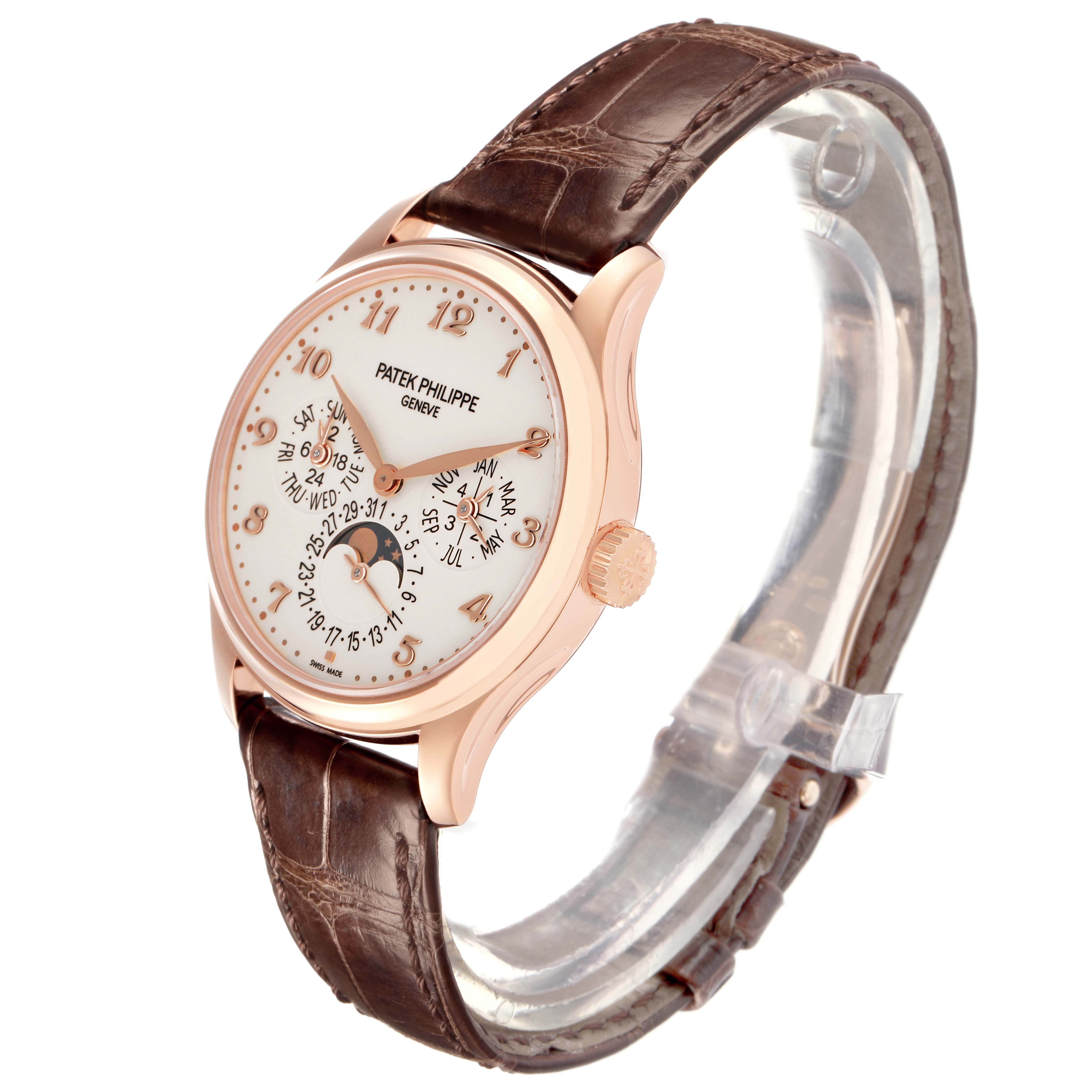 The image shows a Patek Philippe Complications 5327R Men
s Rose Gold White Dial 5327R Men
s Rose Gold White Dial watch at a three-quarter angle, highlighting the case, dial, and brown leather strap.