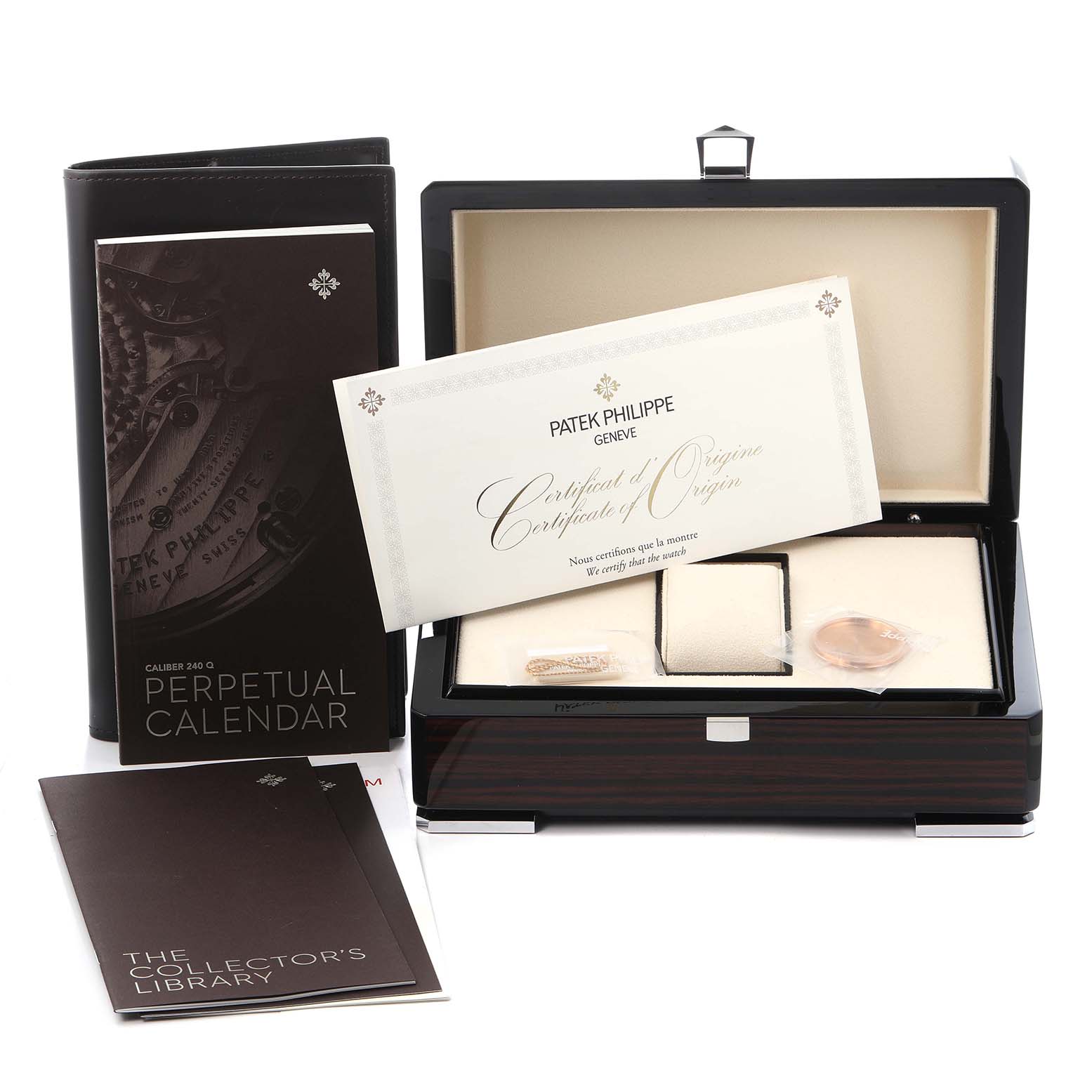 The image shows a Patek Philippe Complications 5327R Men
s Rose Gold White Dial 5327R Men
s Rose Gold White Dial model box, certificates, and booklets at an angle displaying their presentation.