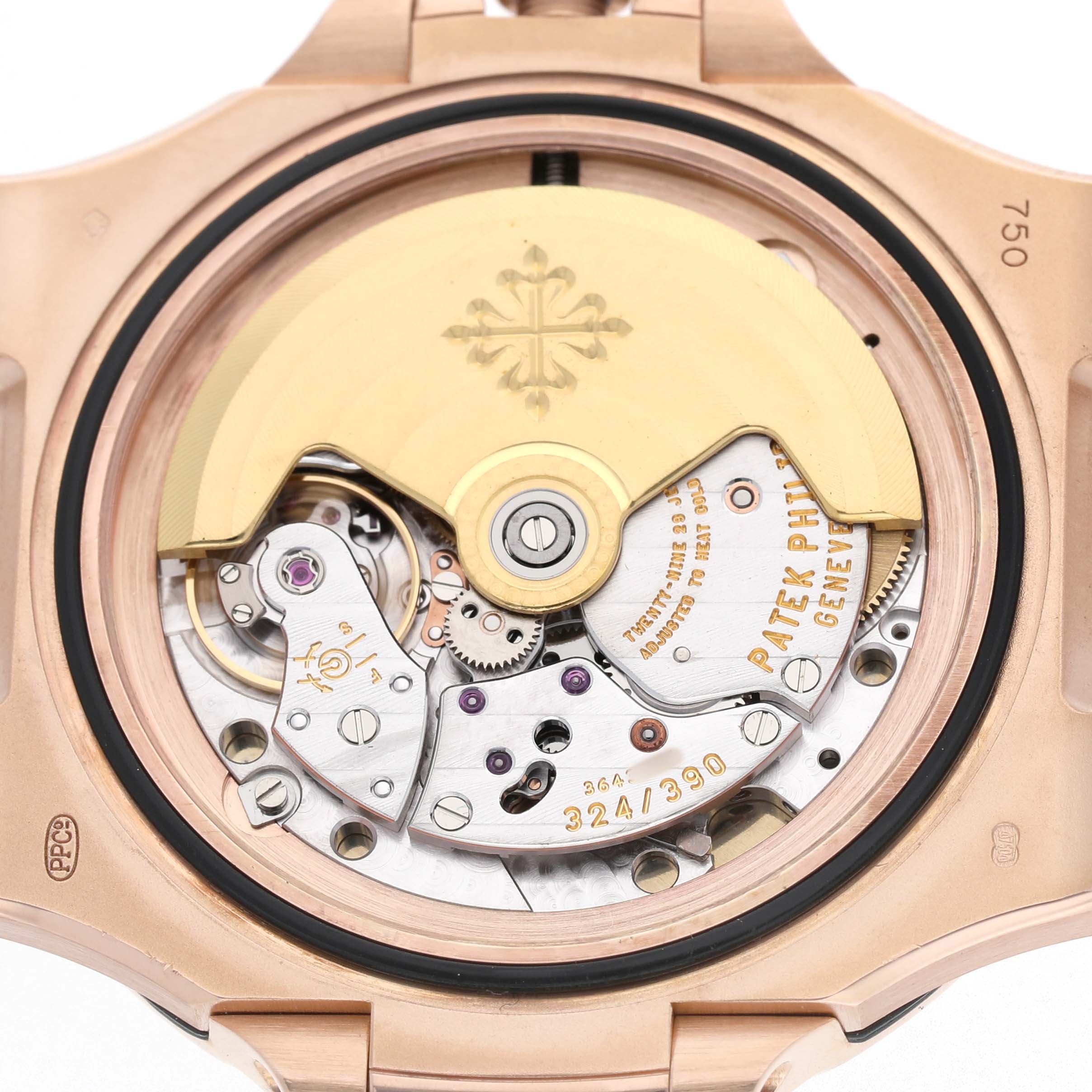 The image shows the open case back of a Patek Philippe Nautilus 5711R-001 Men's Rose Gold Grey Dial, displaying the watch’s movement and rotor.