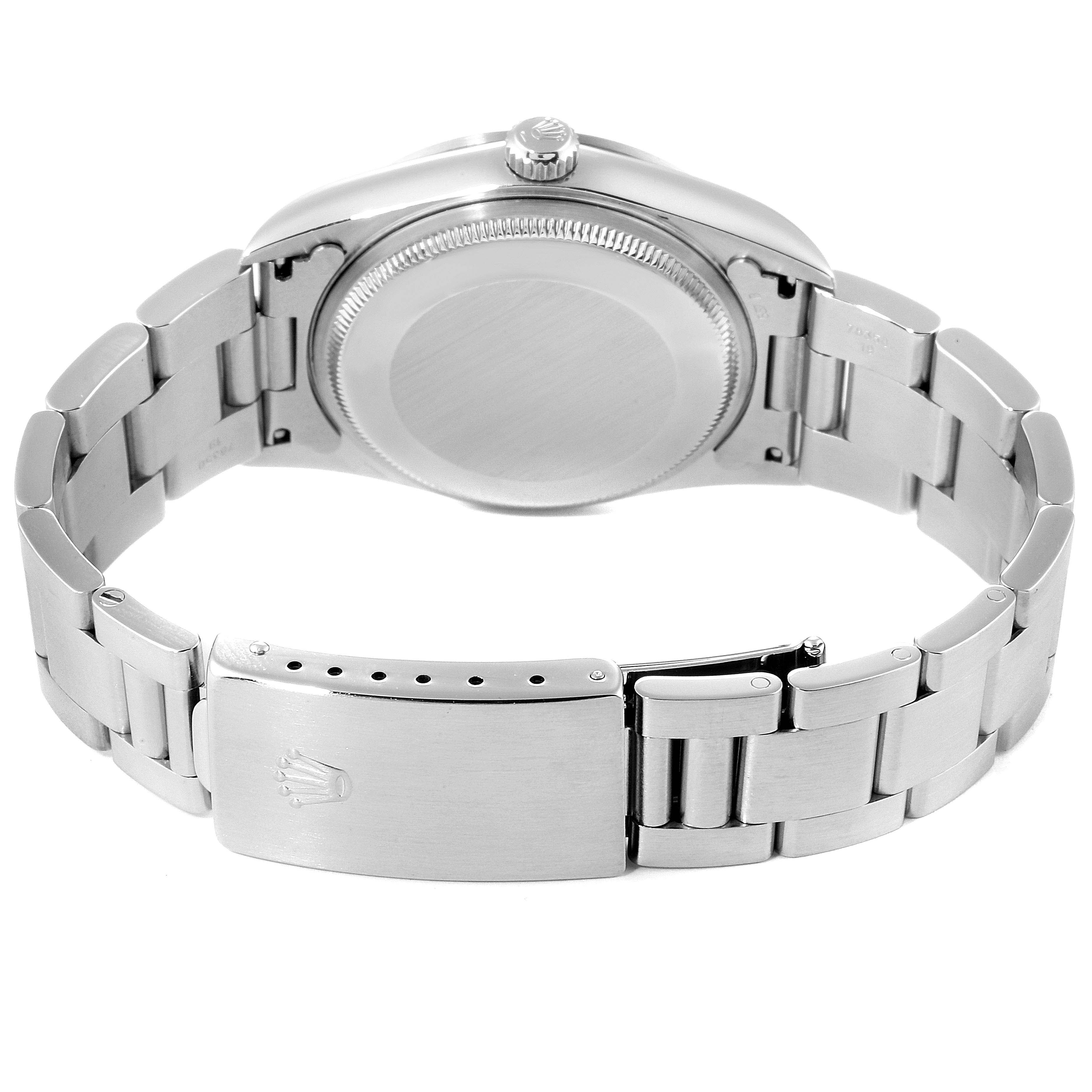 The image shows the back view of an Air-King Rolex watch, showcasing its case back, crown, and bracelet with clasp.