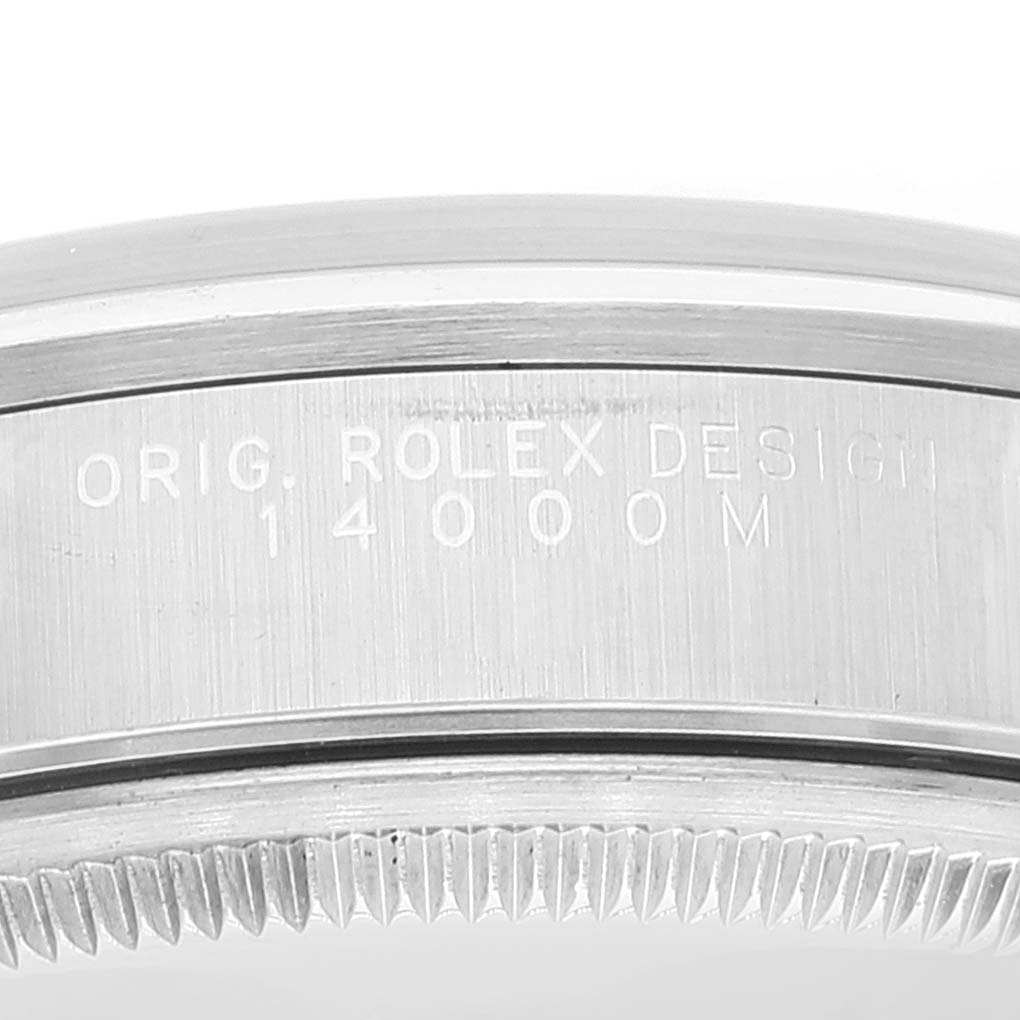 The image shows a close-up angle of the case back and serrated edge of a Rolex Air-King 14000 Men's Stainless Steel Pink Dial 14000 Men's Stainless Steel Pink Dial model, displaying the inscription "ORIG. ROLEX DESIGN 14000M".