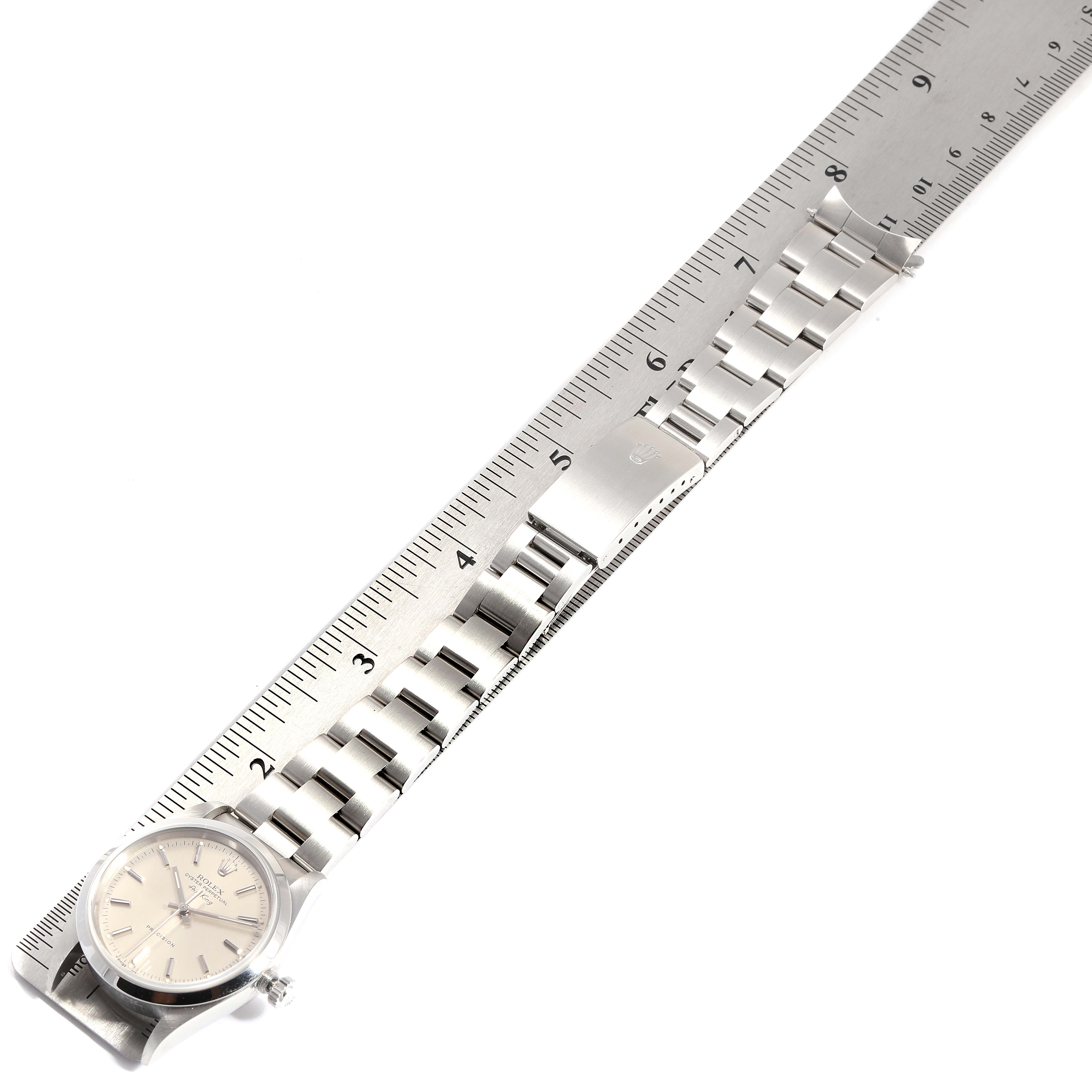 The image shows a Rolex Air-King 14000 Men's Stainless Steel Silver Dial 14000 Men's Stainless Steel Silver Dial watch laid flat on a ruler, highlighting the watch face and metal bracelet from above.